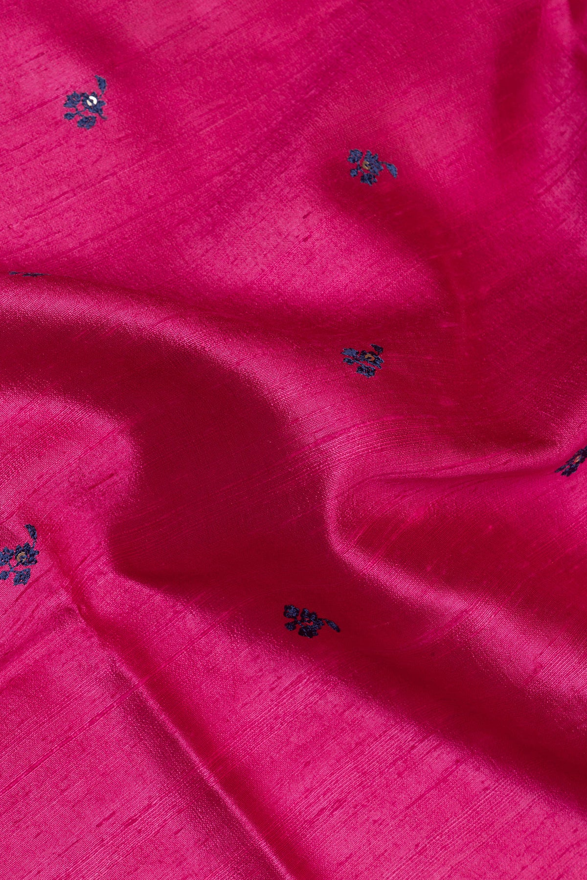 Close up of Pure Silk Pink Raw Saree with Embroidery on the body and Zari Border.  displaying folds