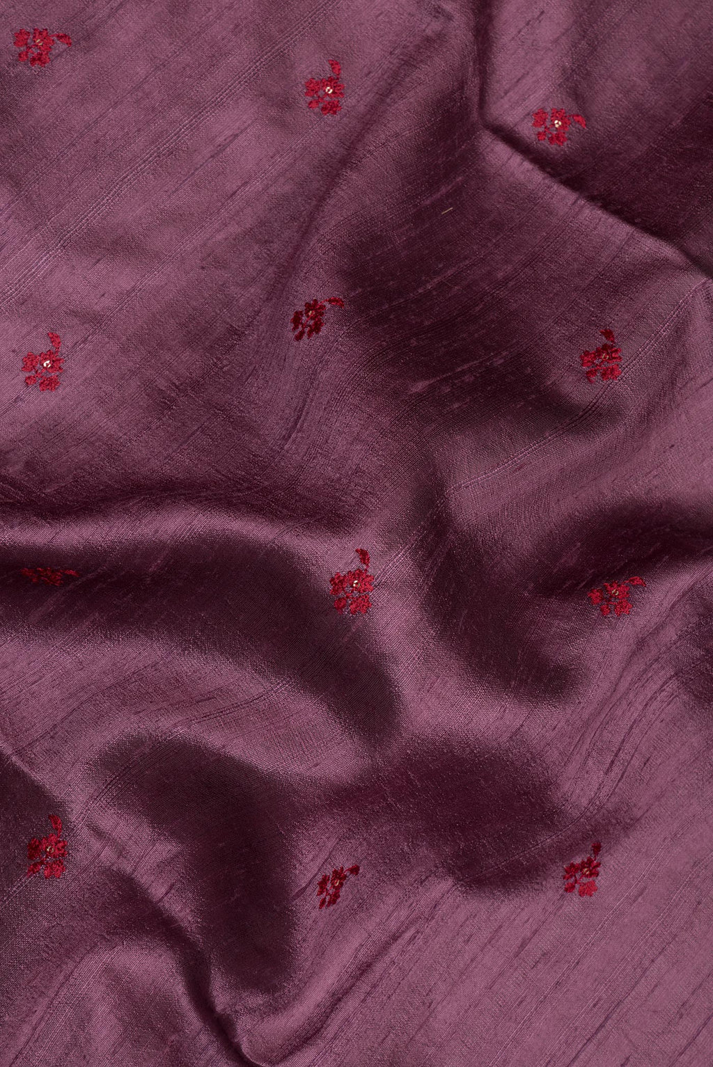 Close up of Pure Silk Mauve Dual Tone Raw Saree with Embroidery on the body and Zari Border.  displaying folds