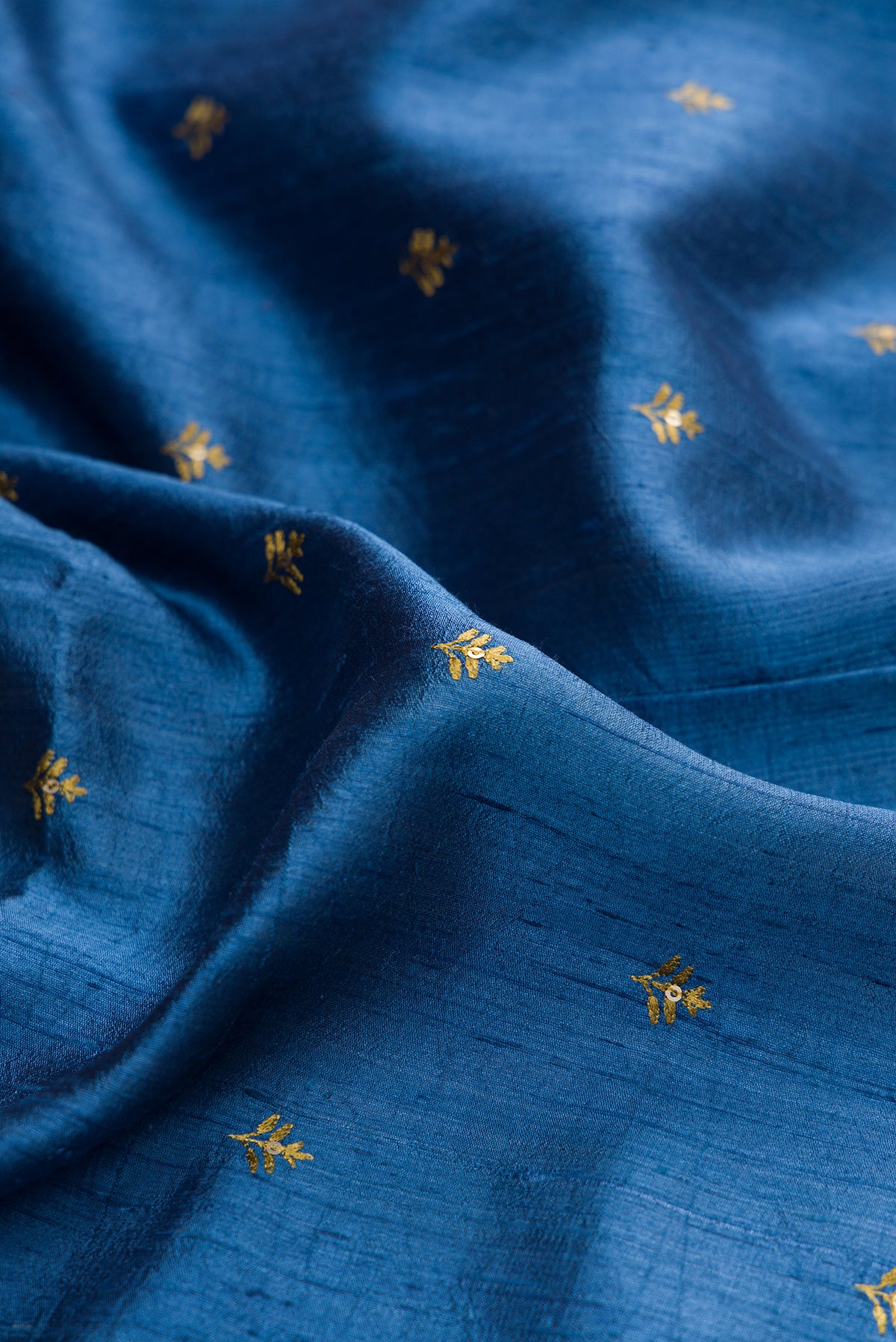 Close up of Blue Tussar Saree with Embroidered on the body and Fancy Border.  displaying folds