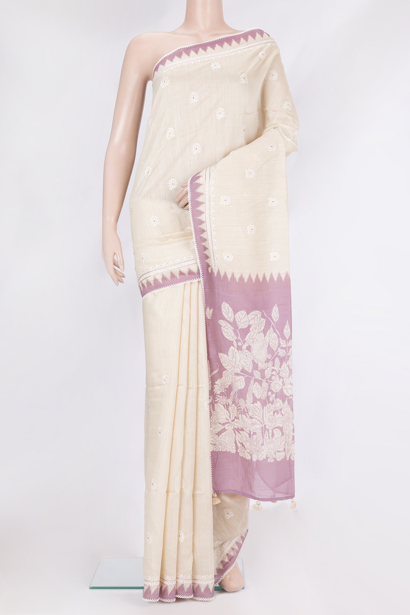 Cream Tussar Saree with Embroidery on the body and Embroidery Border.  displayed on a mannequin