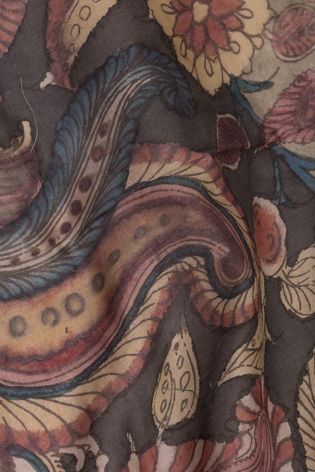 Close up of Multi Color Tussar Saree with kalamkari Print on the body and Zari Border.  displaying folds