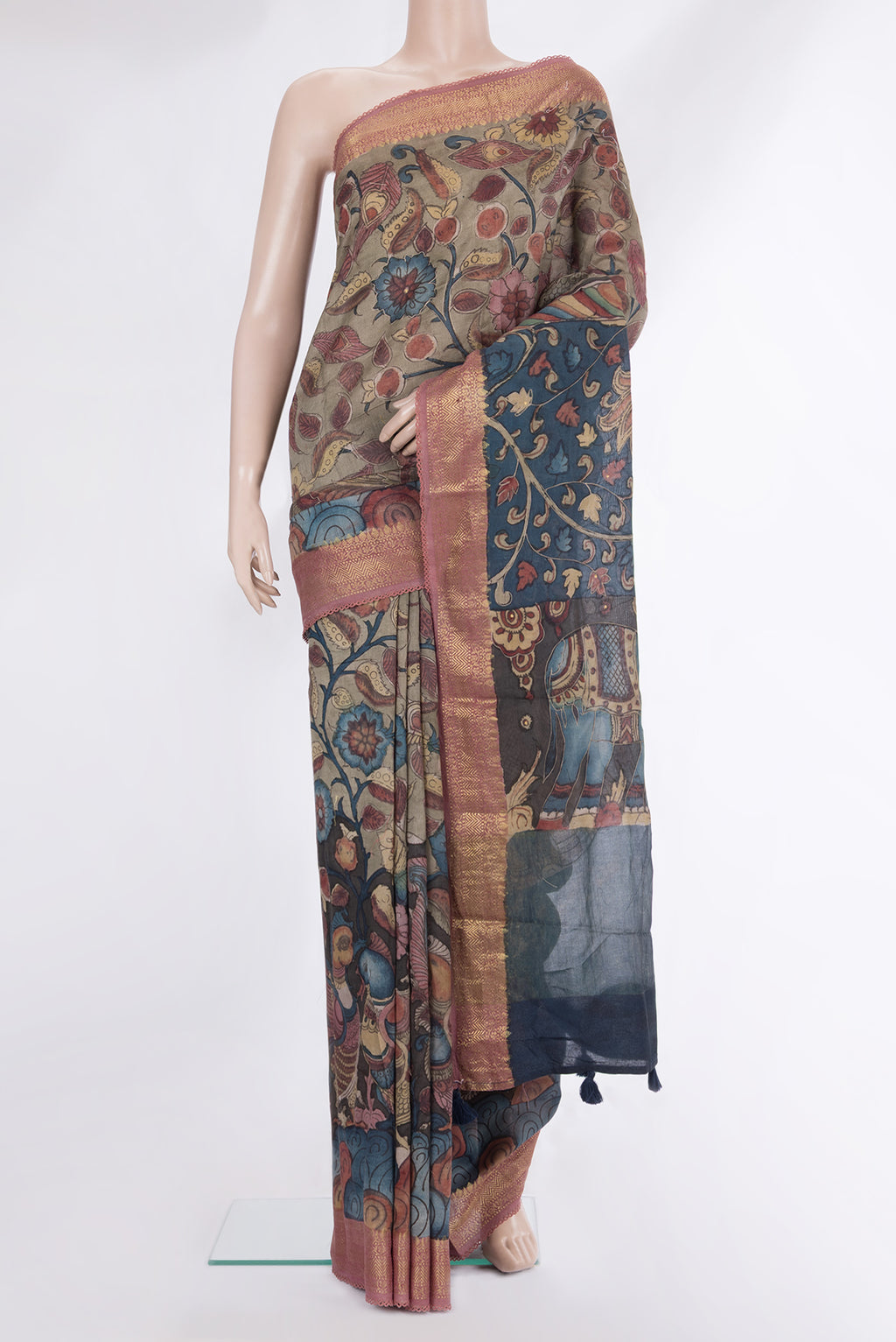 Multi Color Tussar Saree with kalamkari Print on the body and Zari Border.  displayed on a mannequin