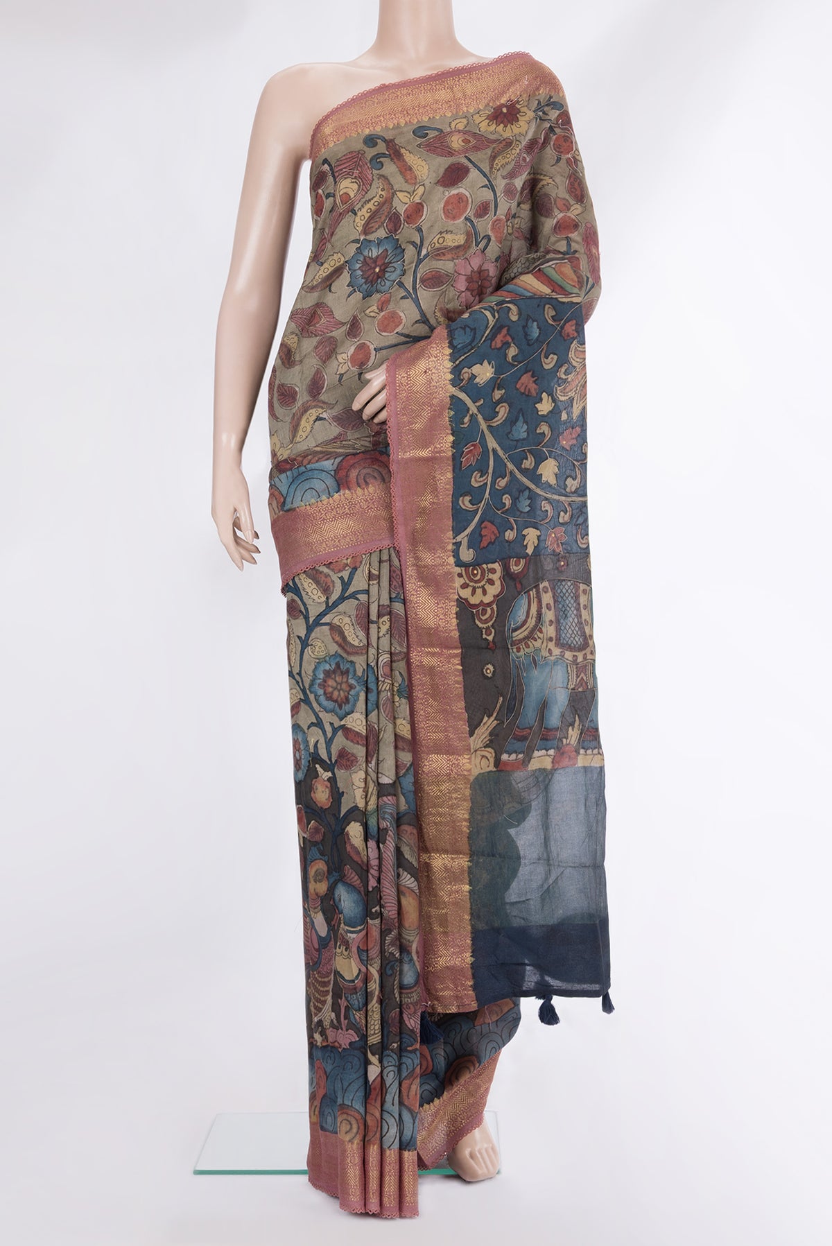 Multi Color Tussar Saree with kalamkari Print on the body and Zari Border.  displayed on a mannequin