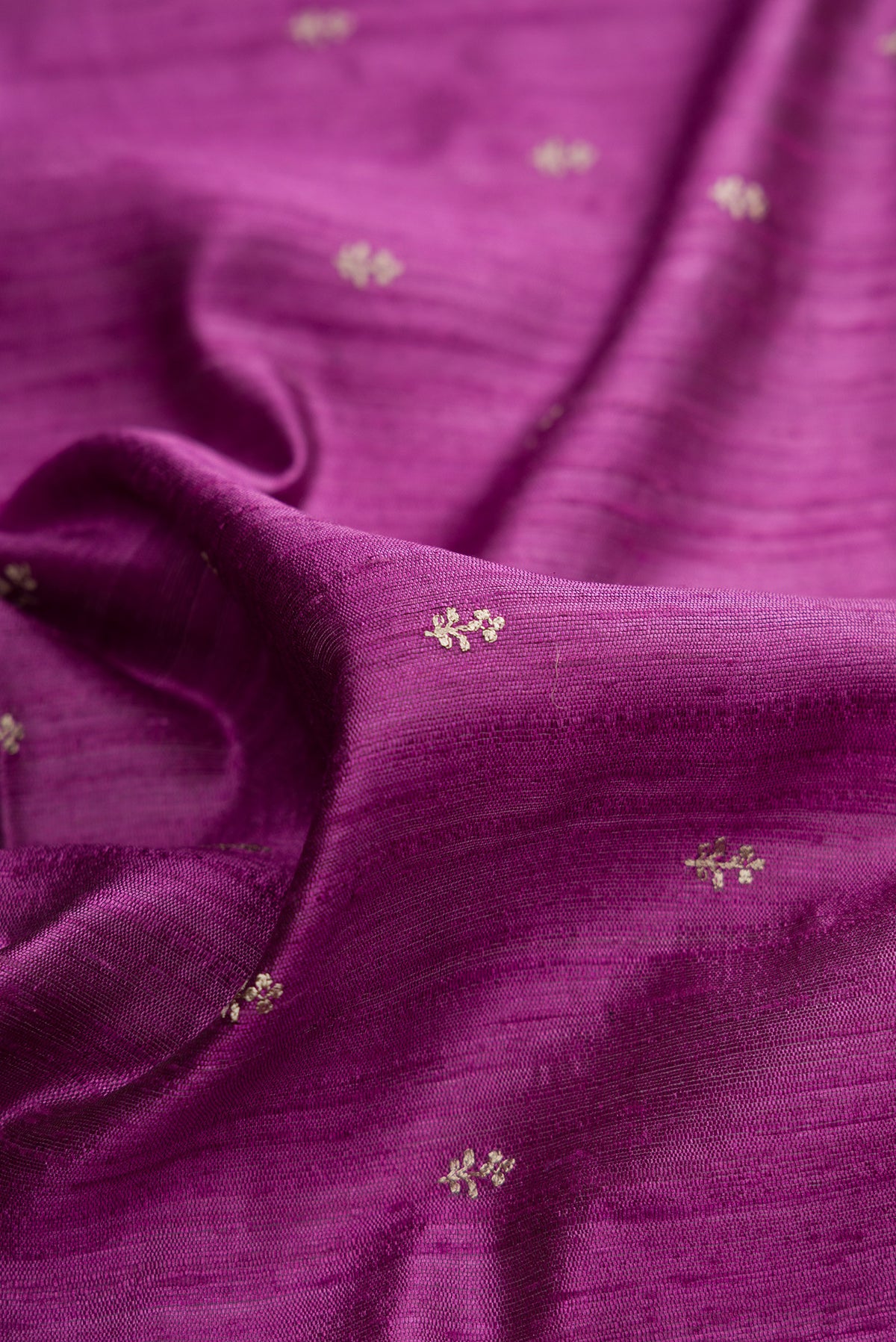Close up of Light Magenta Tussar Saree with Thread Butta on the body and Embroidered Border.  displaying folds
