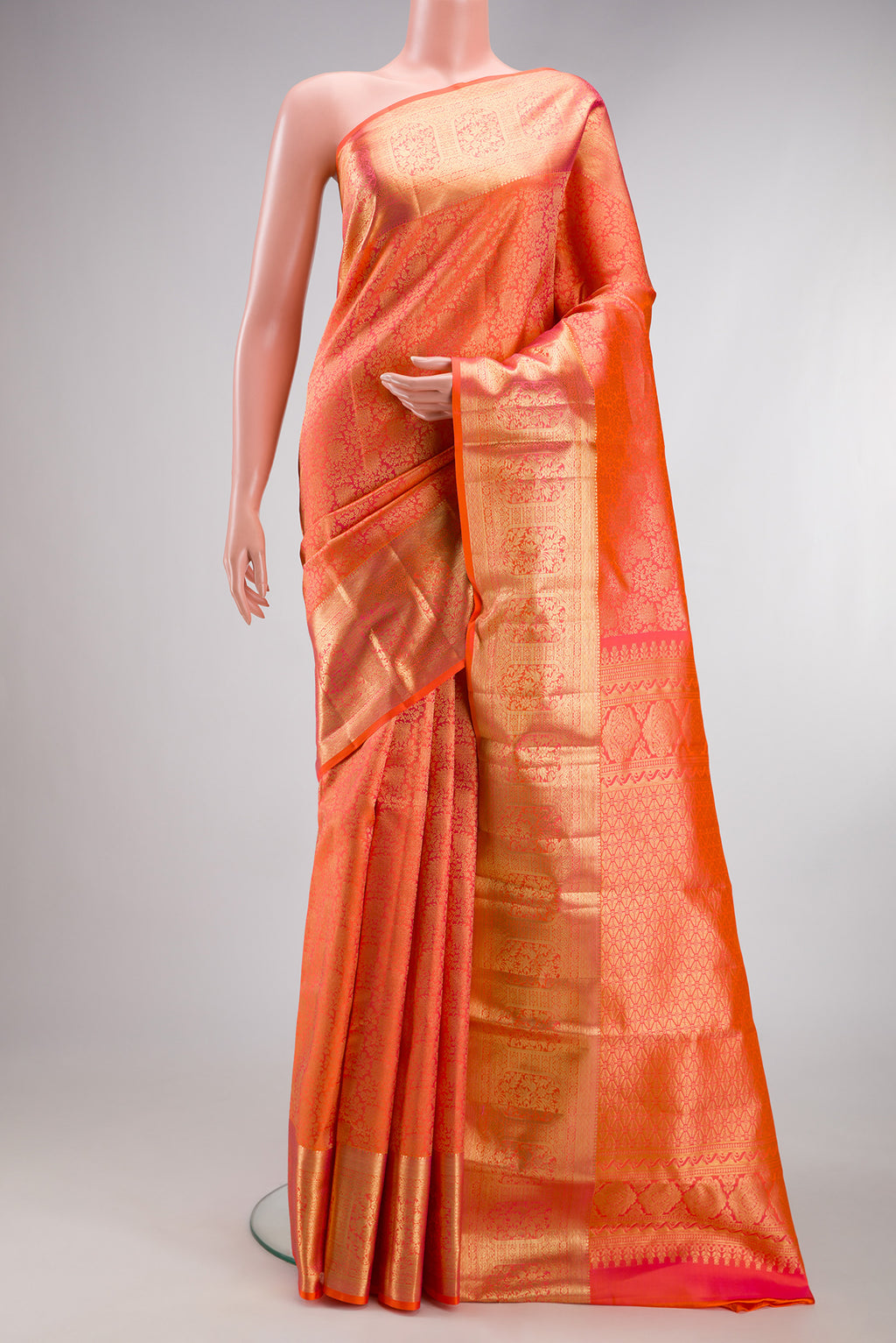 Coral Dual Tone Kanchipuram Silk Saree with Zari Brocade on the body and Zari Border.  displayed on a mannequin