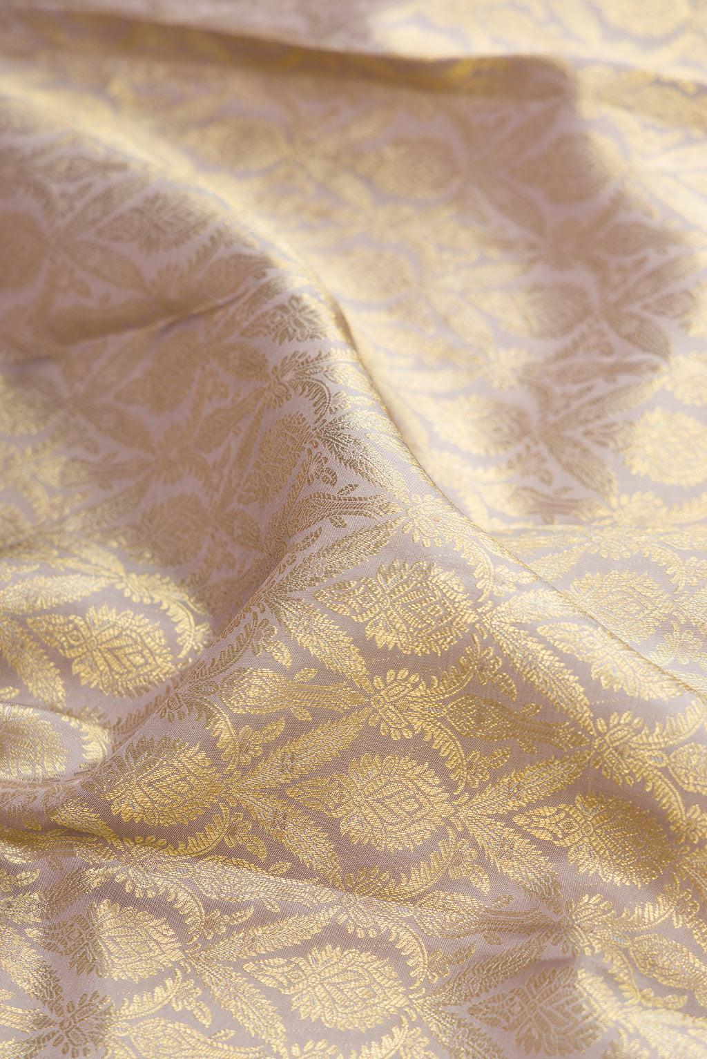 Close up of Davys Grey Kanchipuram Silk Saree with Zari Brocade on the body and Zari Border.  displaying folds