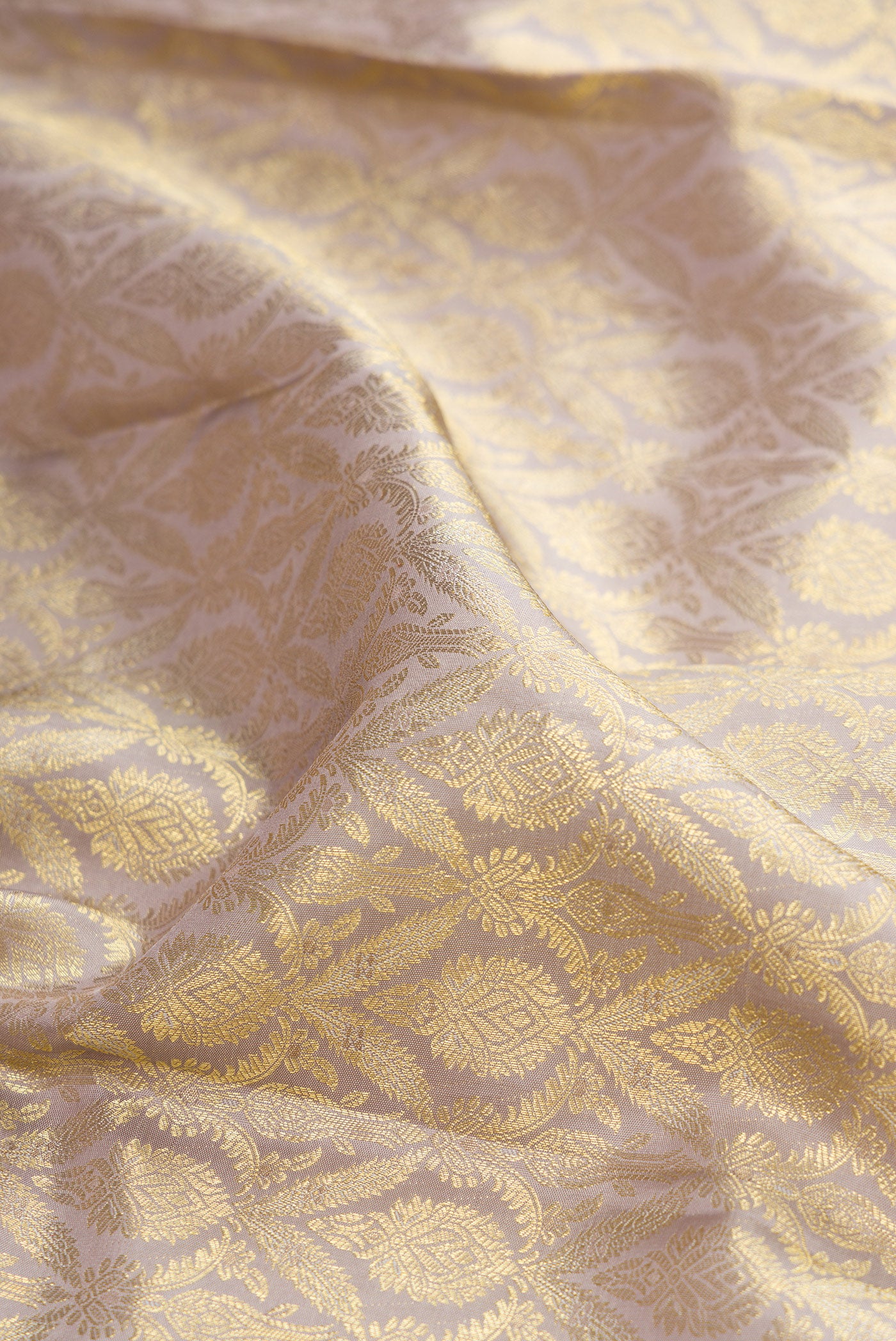 Close up of Davys Grey Kanchipuram Silk Saree with Zari Brocade on the body and Zari Border.  displaying folds