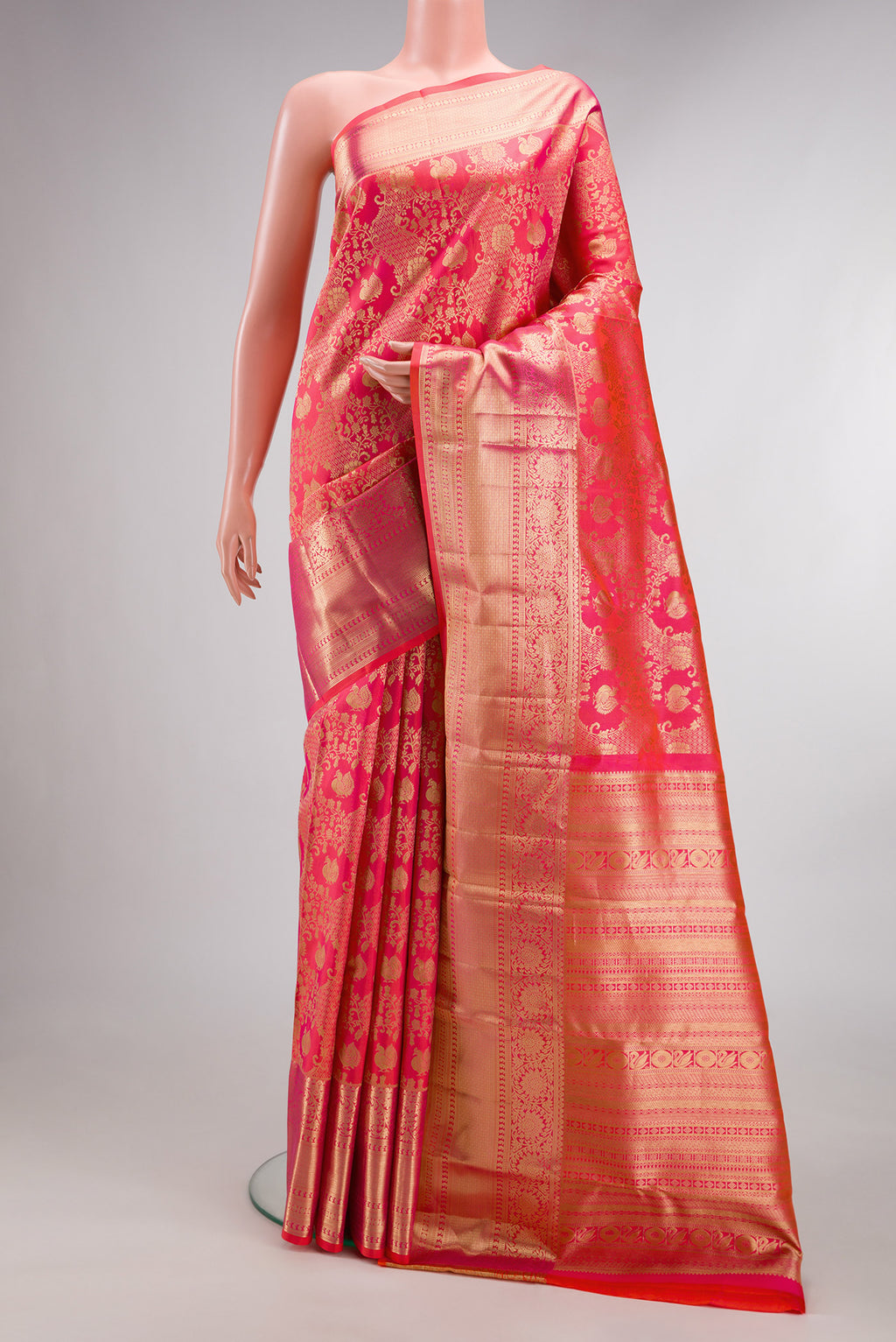 Pure Silk Pink Dual Tone Kanchipuram Saree with Zari Brocade on the body and Fancy Border.  displayed on a mannequin