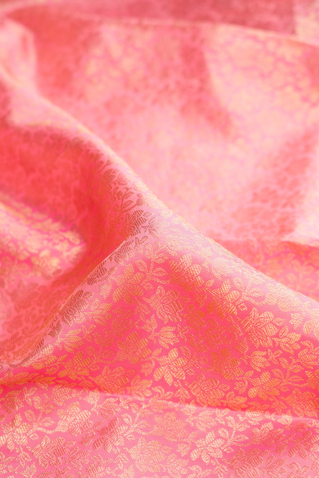 Close up of Pure Silk Rose pink Dual Tone Kanchipuram Saree with Zari Brocade on the body and Zari Border.  displaying folds