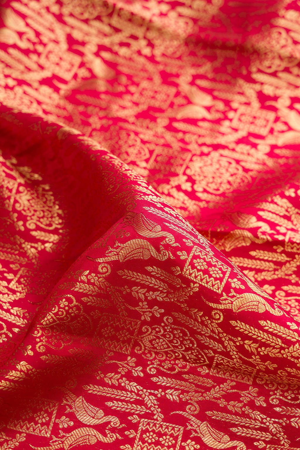 Close up of Pure Silk Red Dual Tone Kanchipuram Saree with Zari Brocade on the body and Zari Border.  displaying folds