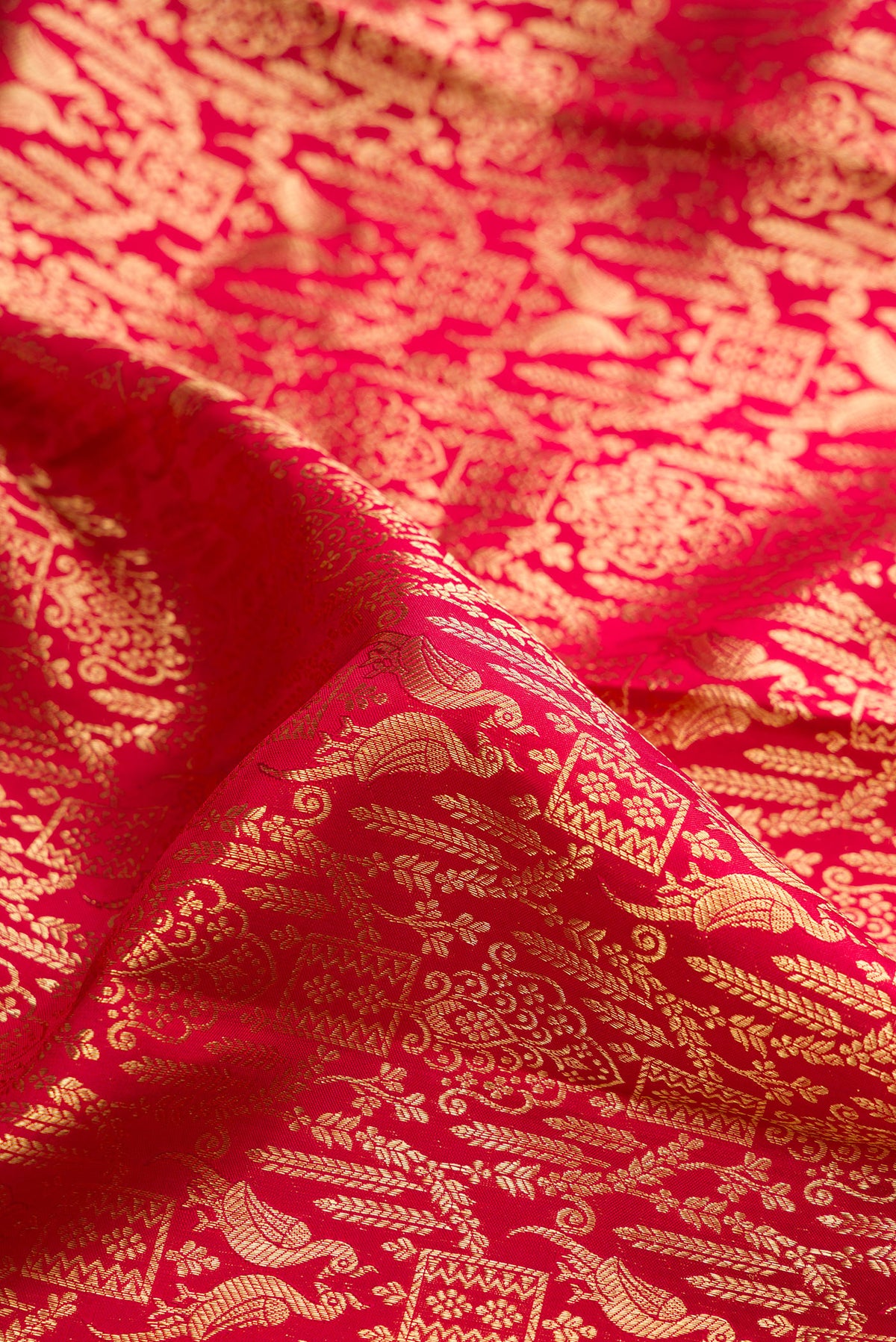 Close up of Pure Silk Red Dual Tone Kanchipuram Saree with Zari Brocade on the body and Zari Border.  displaying folds