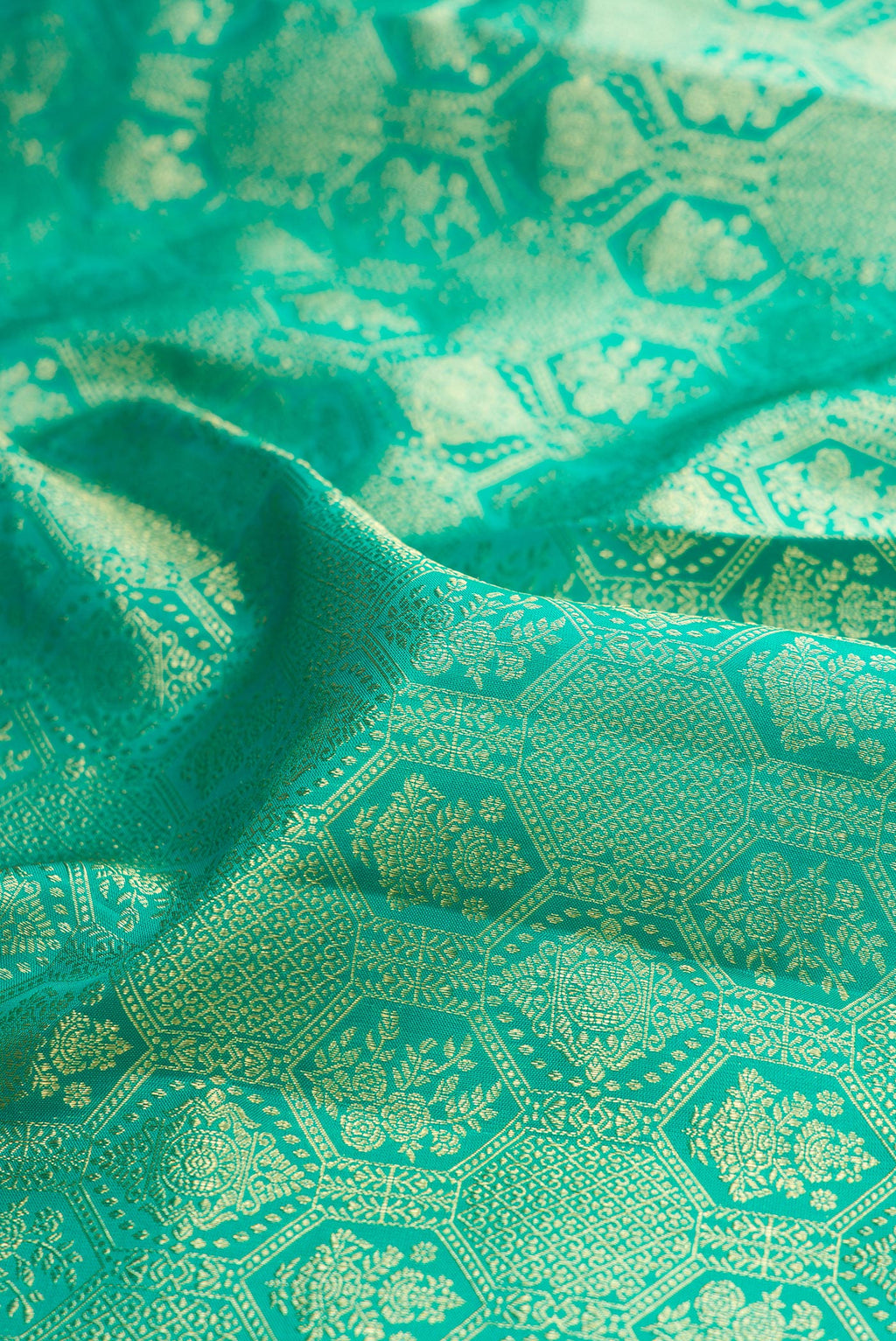 Close up of Sea Green Kanchipuram Silk Saree with Zari Brocade on the body and Zari Border.  displaying folds