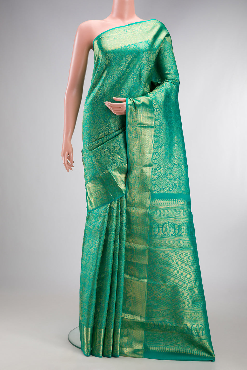 Sea Green Kanchipuram Silk Saree with Zari Brocade on the body and Zari Border.  displayed on a mannequin