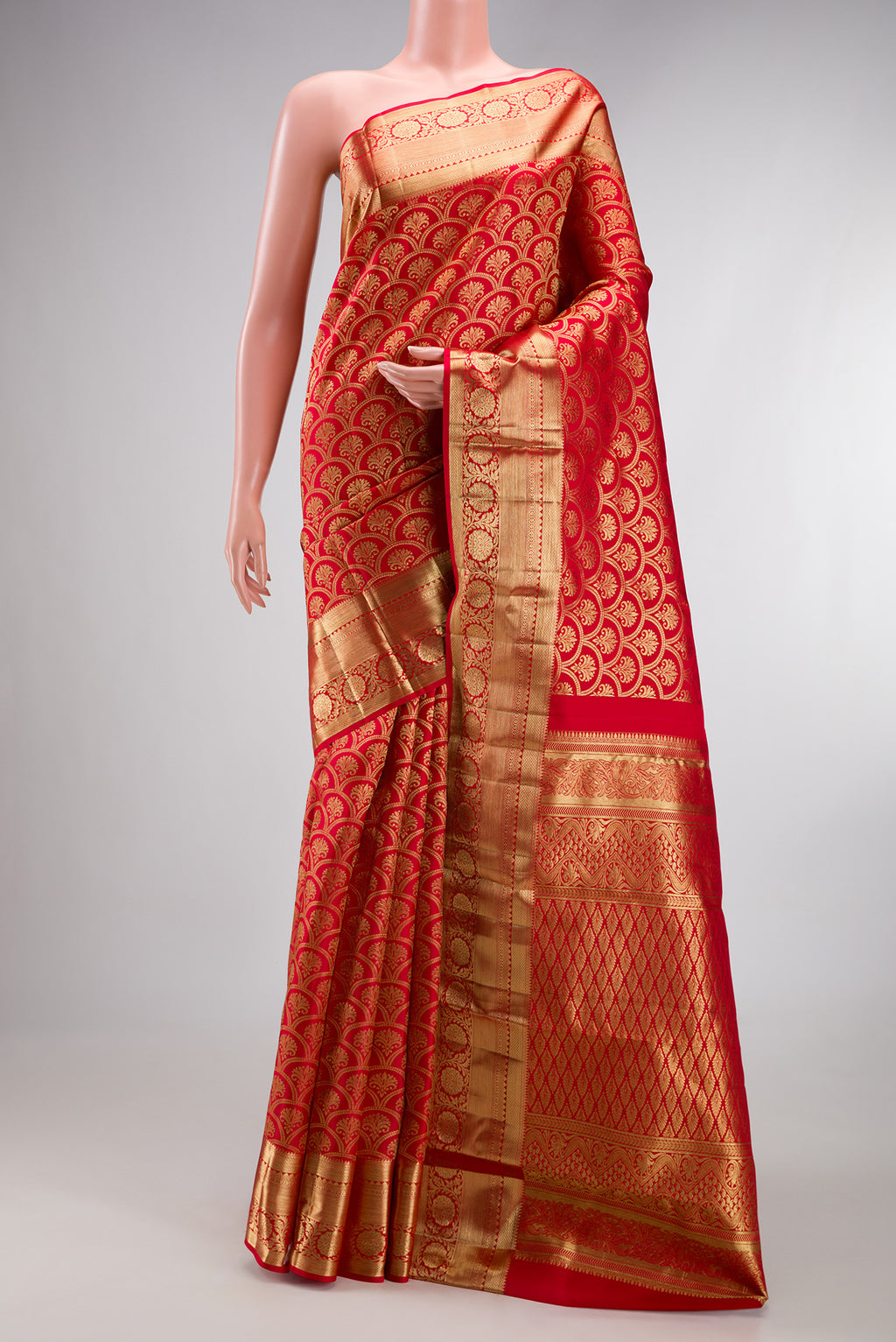 Red Kanchipuram Silk Saree with Zari Brocade on the body and Zari Border.  displayed on a mannequin