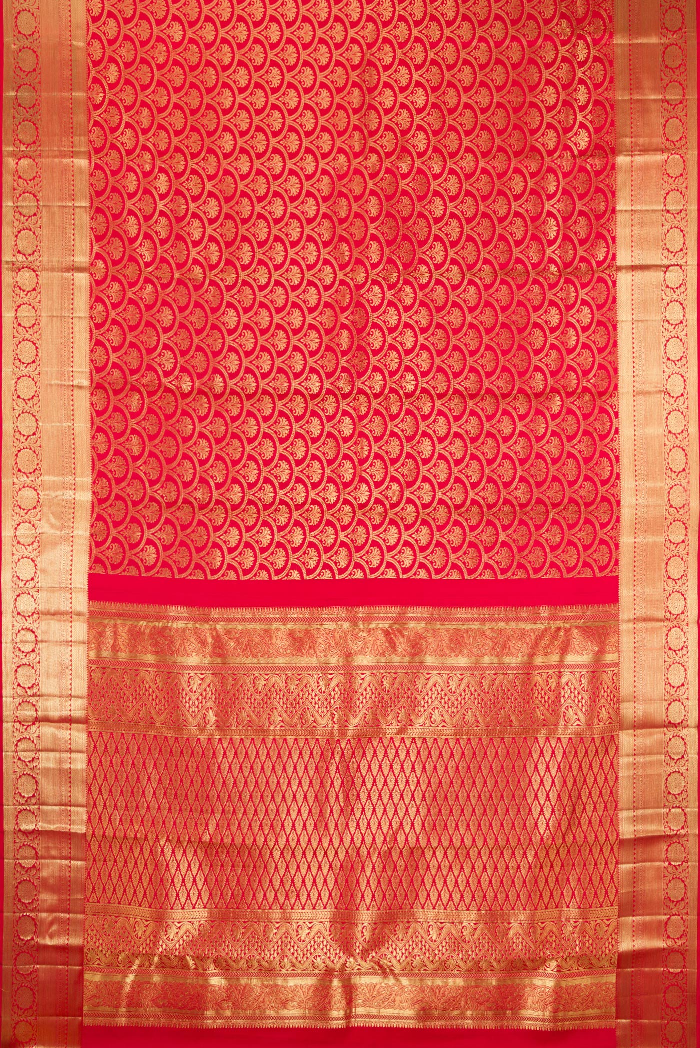 Flat view of Red Kanchipuram Silk Saree with Zari Brocade on the body and Zari Border. 