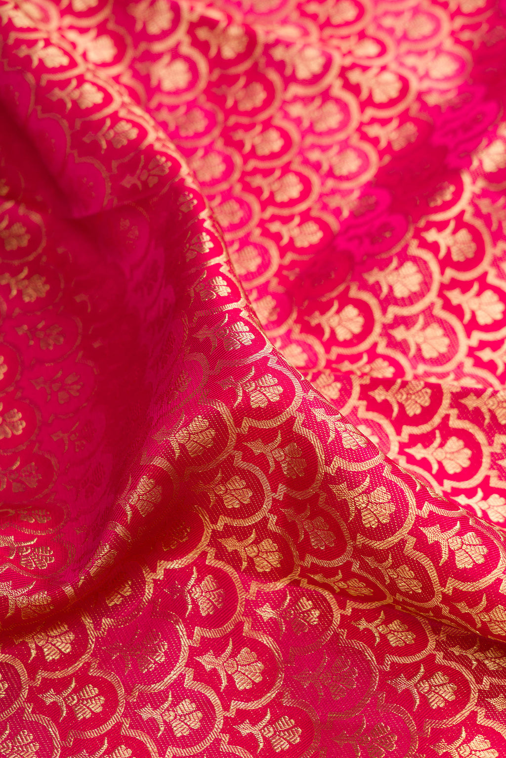 Close up of Pure Silk Dark Pink Dual Tone Kanchipuram Saree with Zari Brocade on the body and Zari Border.  displaying folds