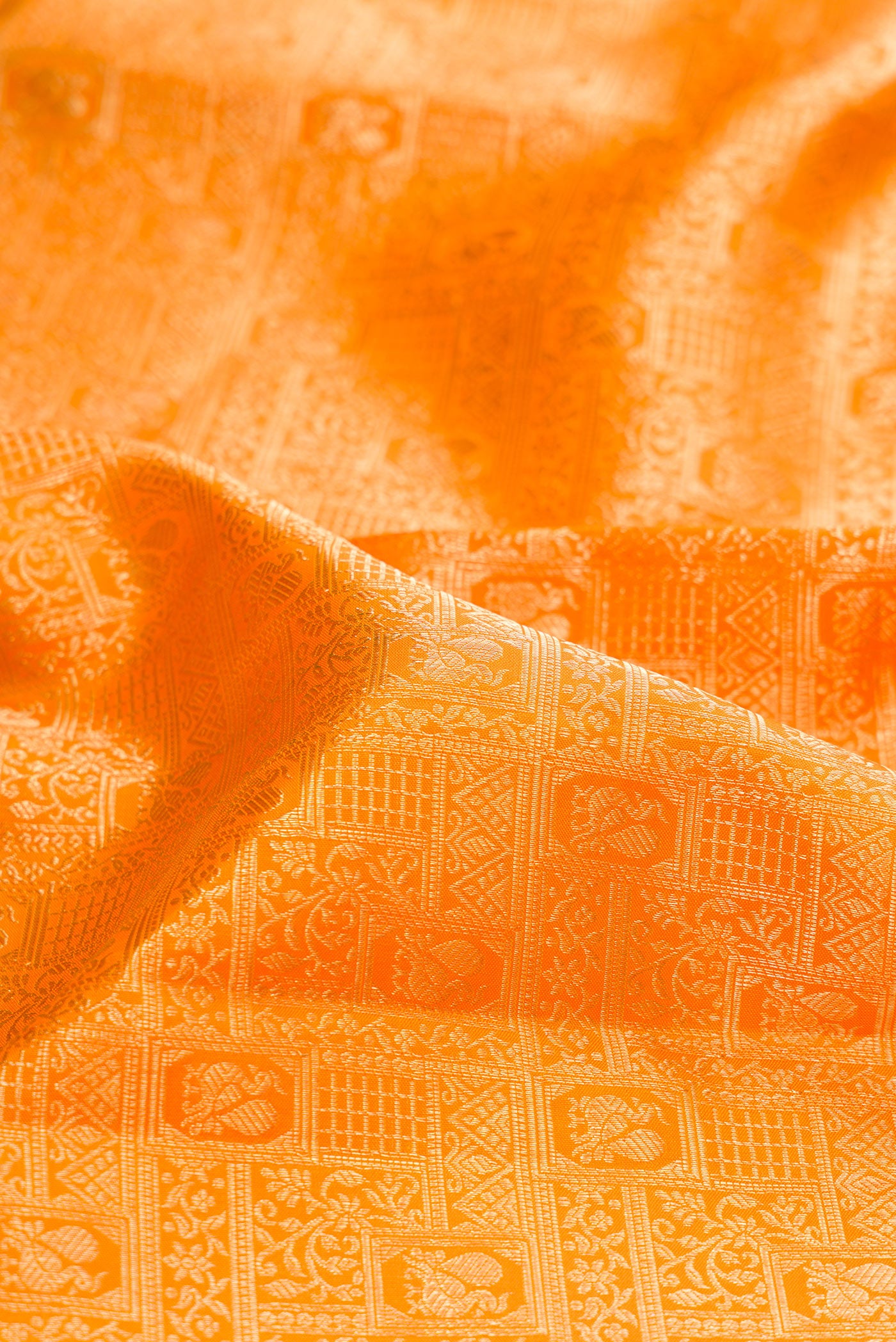 Close up of Pure Silk Yellow Kanchipuram Saree with Zari Brocade on the body and Zari Border.  displaying folds
