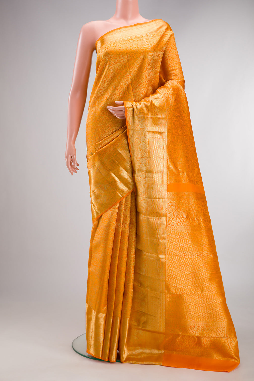 Pure Silk Yellow Kanchipuram Saree with Zari Brocade on the body and Zari Border.  displayed on a mannequin