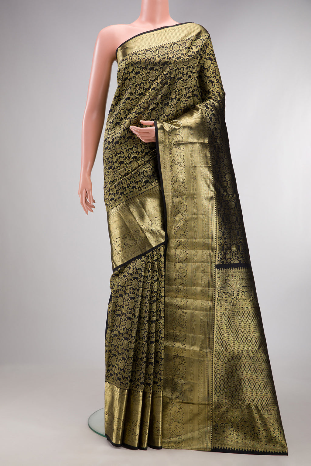 Pure Silk Black Kanchipuram Saree with Zari Brocade on the body and Zari Border.  displayed on a mannequin