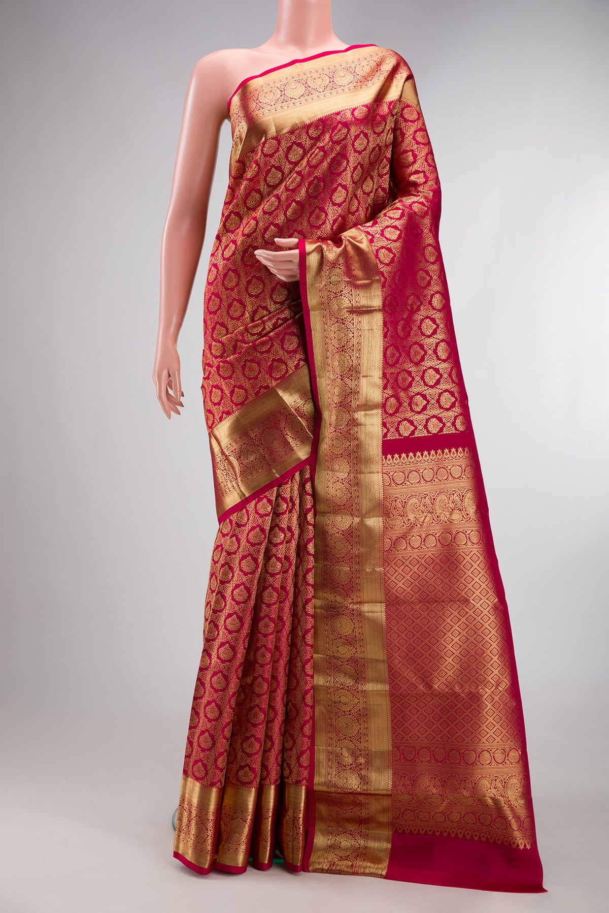 Pure Silk Rani Pink Kanchipuram Saree with Zari Brocade on the body and Zari Border.  displayed on a mannequin