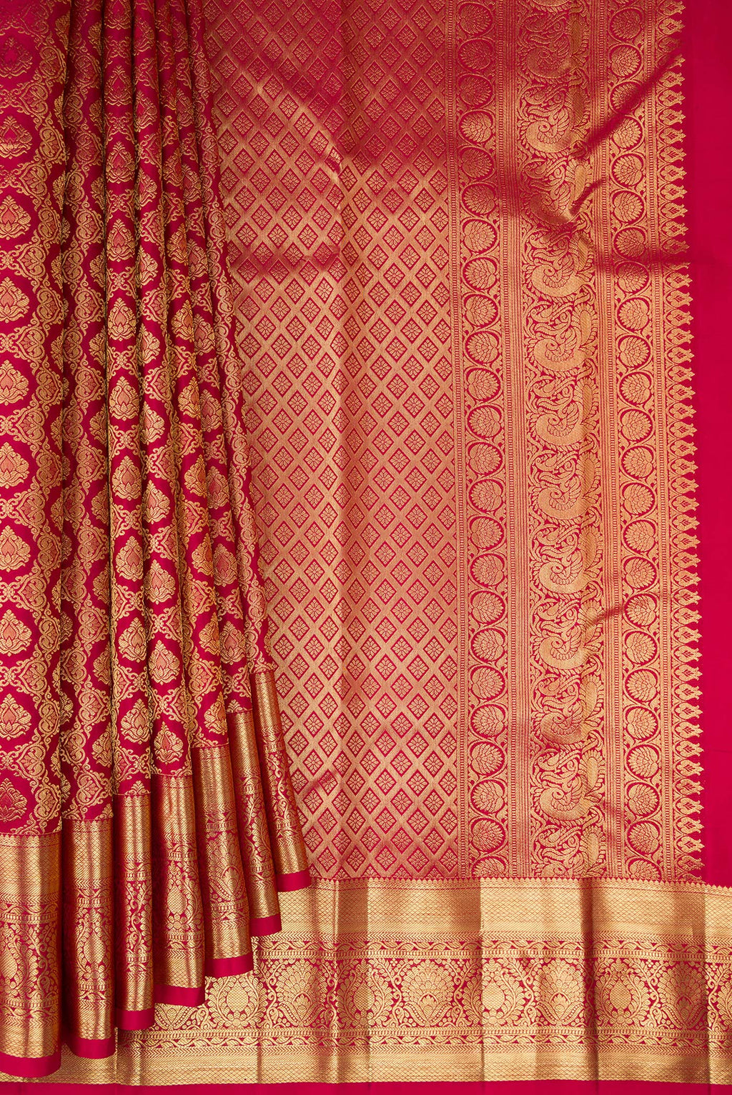 Pleats and pallu of Pure Silk Rani Pink Kanchipuram Saree with Zari Brocade on the body and Zari Border. 
