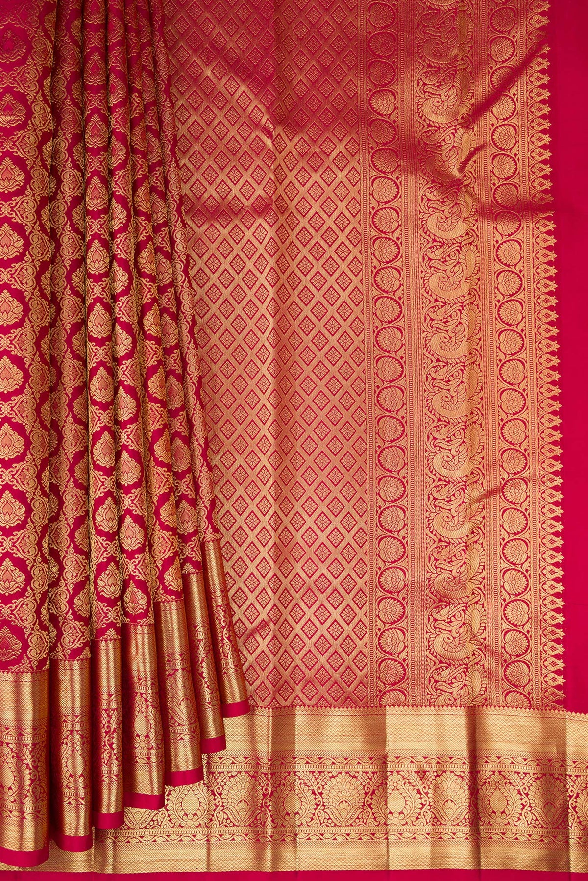 Pleats and pallu of Pure Silk Rani Pink Kanchipuram Saree with Zari Brocade on the body and Zari Border. 