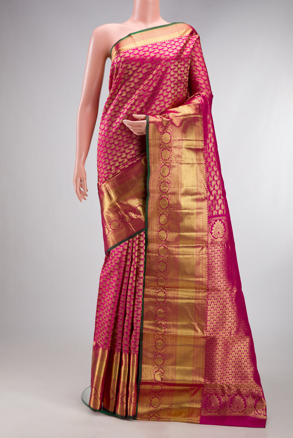 Rani Pink Kanchipuram Silk Saree with Zari Brocade on the body and Zari Border.  displayed on a mannequin