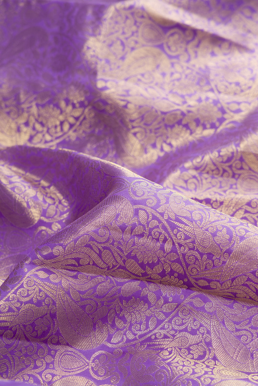 Close up of Lavender Kanchipuram Silk Saree with Zari Brocade on the body and Zari Border.  displaying folds