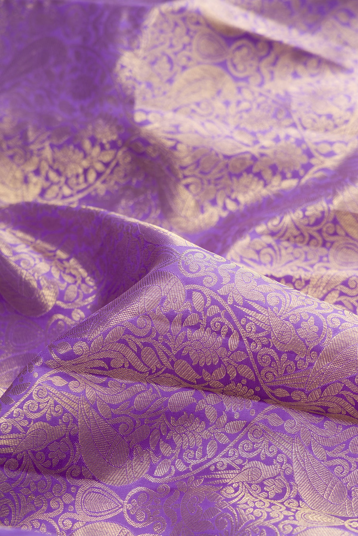 Close up of Lavender Kanchipuram Silk Saree with Zari Brocade on the body and Zari Border.  displaying folds