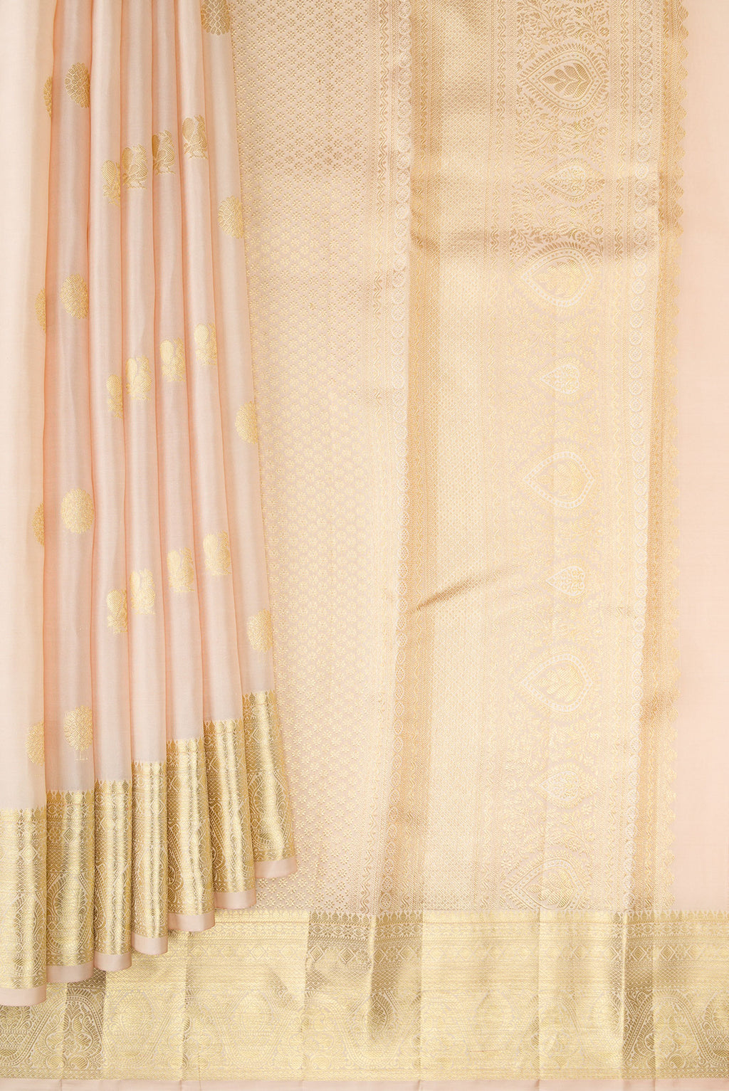 Pleats and pallu of Cream Kanchipuram Silk Saree with Zari Butta on the body and Zari Border. 