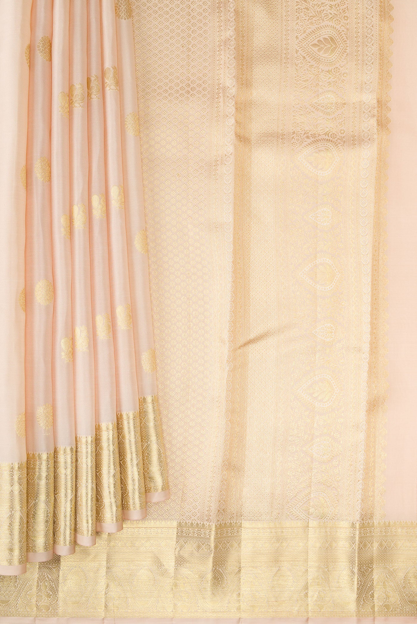 Pleats and pallu of Cream Kanchipuram Silk Saree with Zari Butta on the body and Zari Border. 