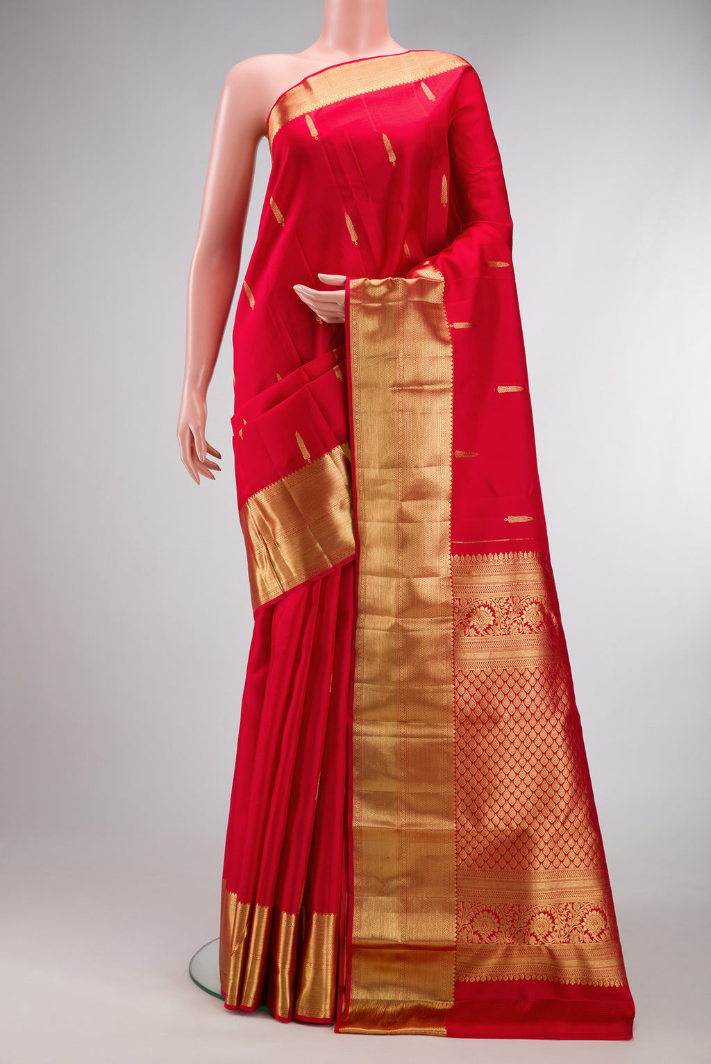 Red Kanchipuram Silk Saree with Zari Butta on the body and Zari Border.  displayed on a mannequin