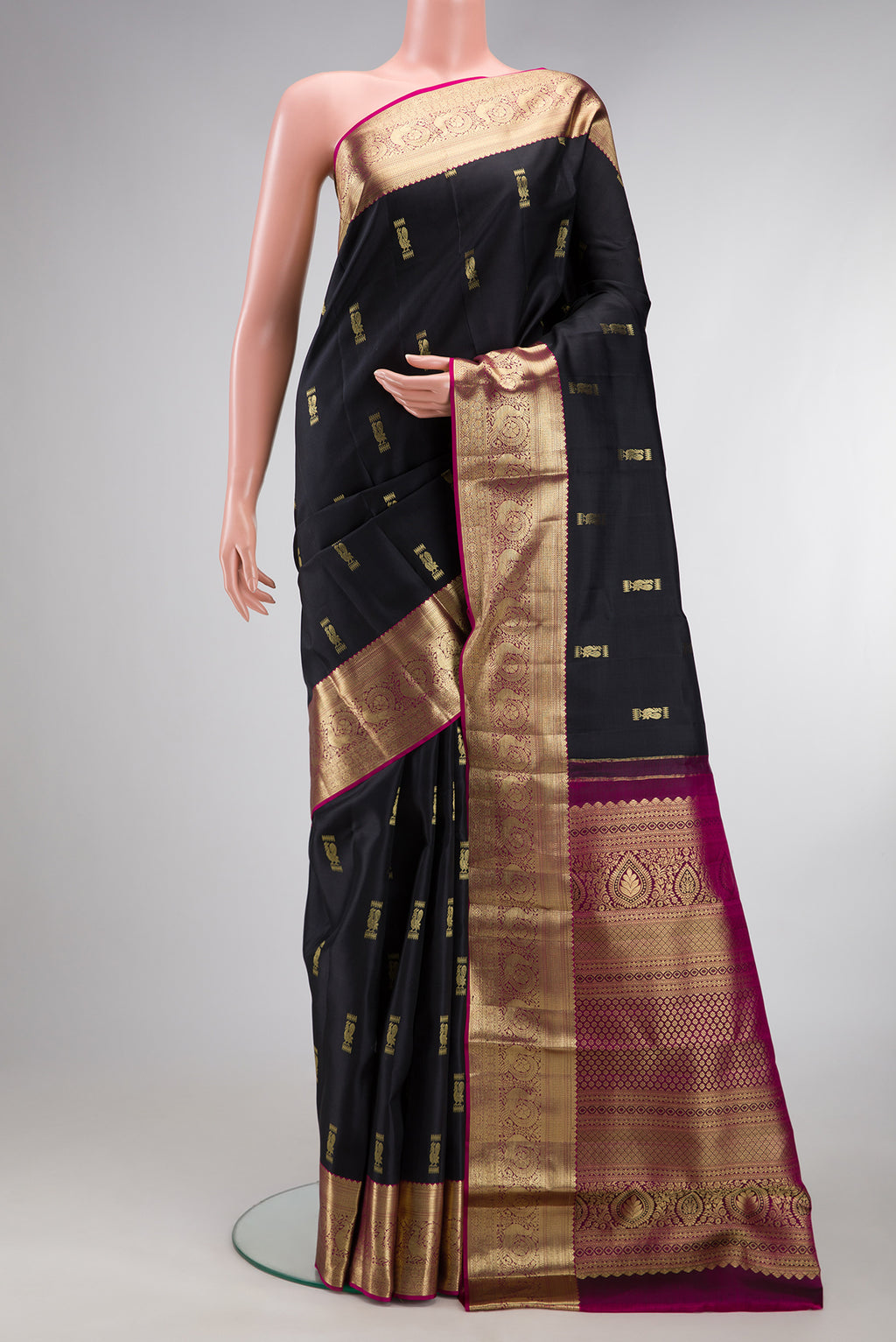 Black Kanchipuram Silk Saree with Zari Butta on the body and Zari Border.  displayed on a mannequin