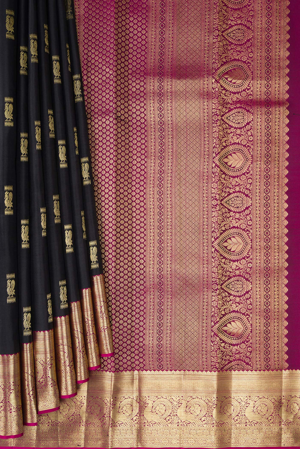 Pleats and pallu of Black Kanchipuram Silk Saree with Zari Butta on the body and Zari Border. 