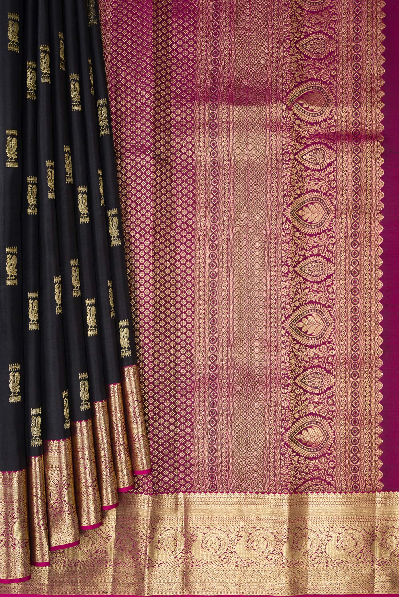 Pleats and pallu of Black Kanchipuram Silk Saree with Zari Butta on the body and Zari Border. 