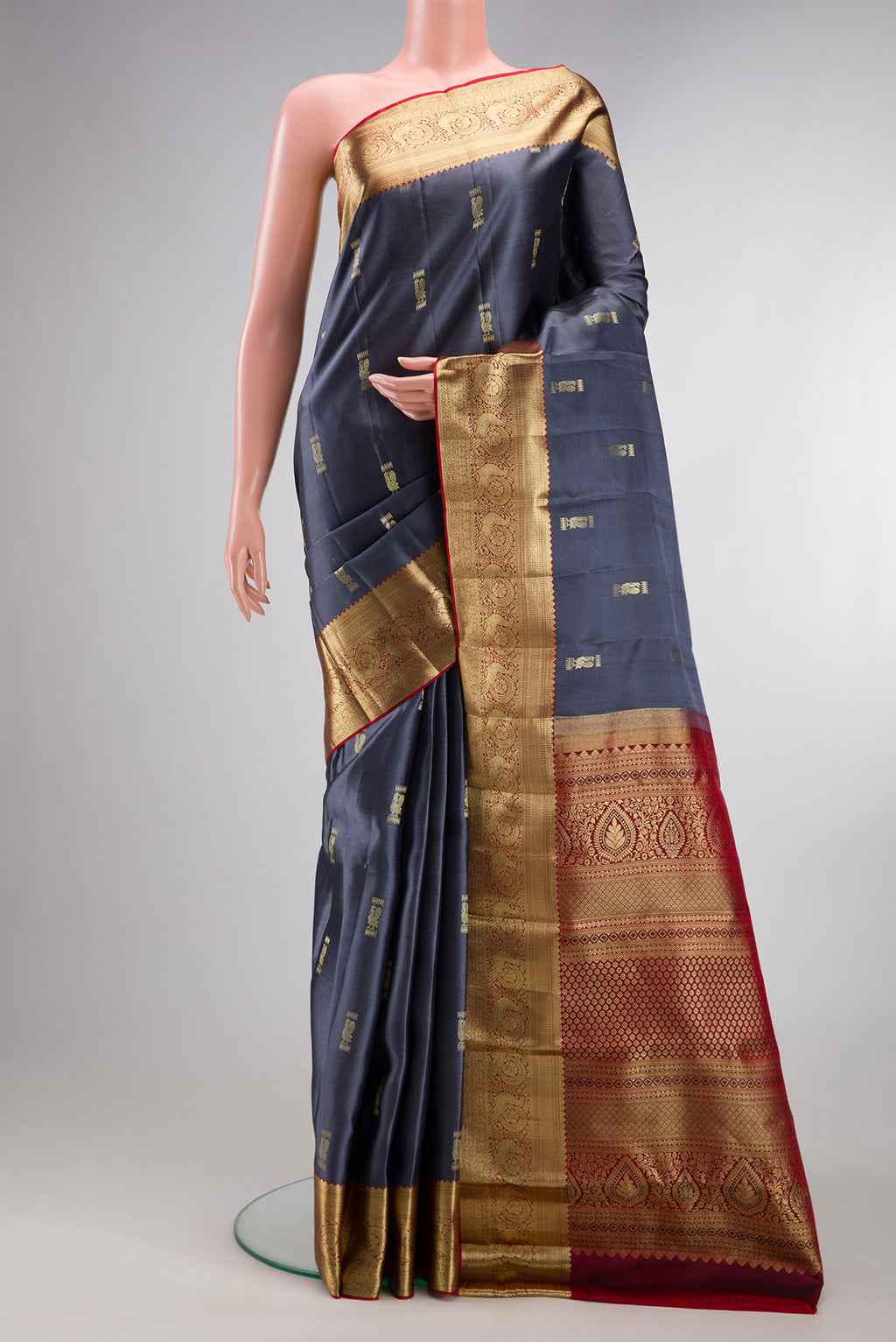Pure Silk Grey Kanchipuram Saree with Zari Butta on the body and Zari Border.  displayed on a mannequin