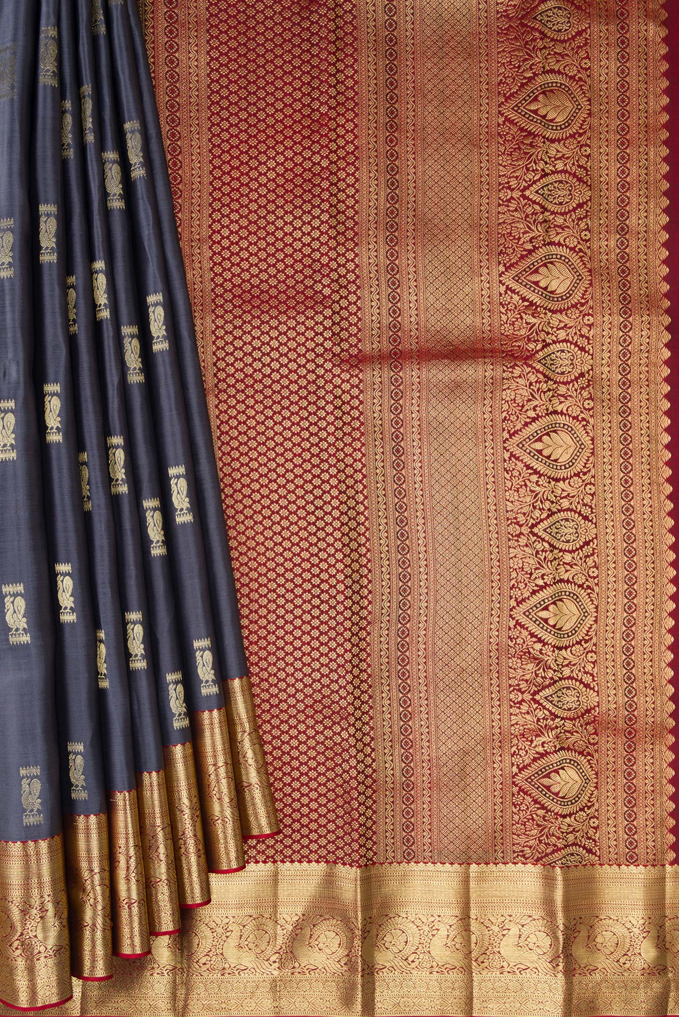 Pleats and pallu of Pure Silk Grey Kanchipuram Saree with Zari Butta on the body and Zari Border. 