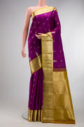 Purple Kanchipuram Silk Saree with Zari Butta on the body and Zari Border.  displayed on a mannequin
