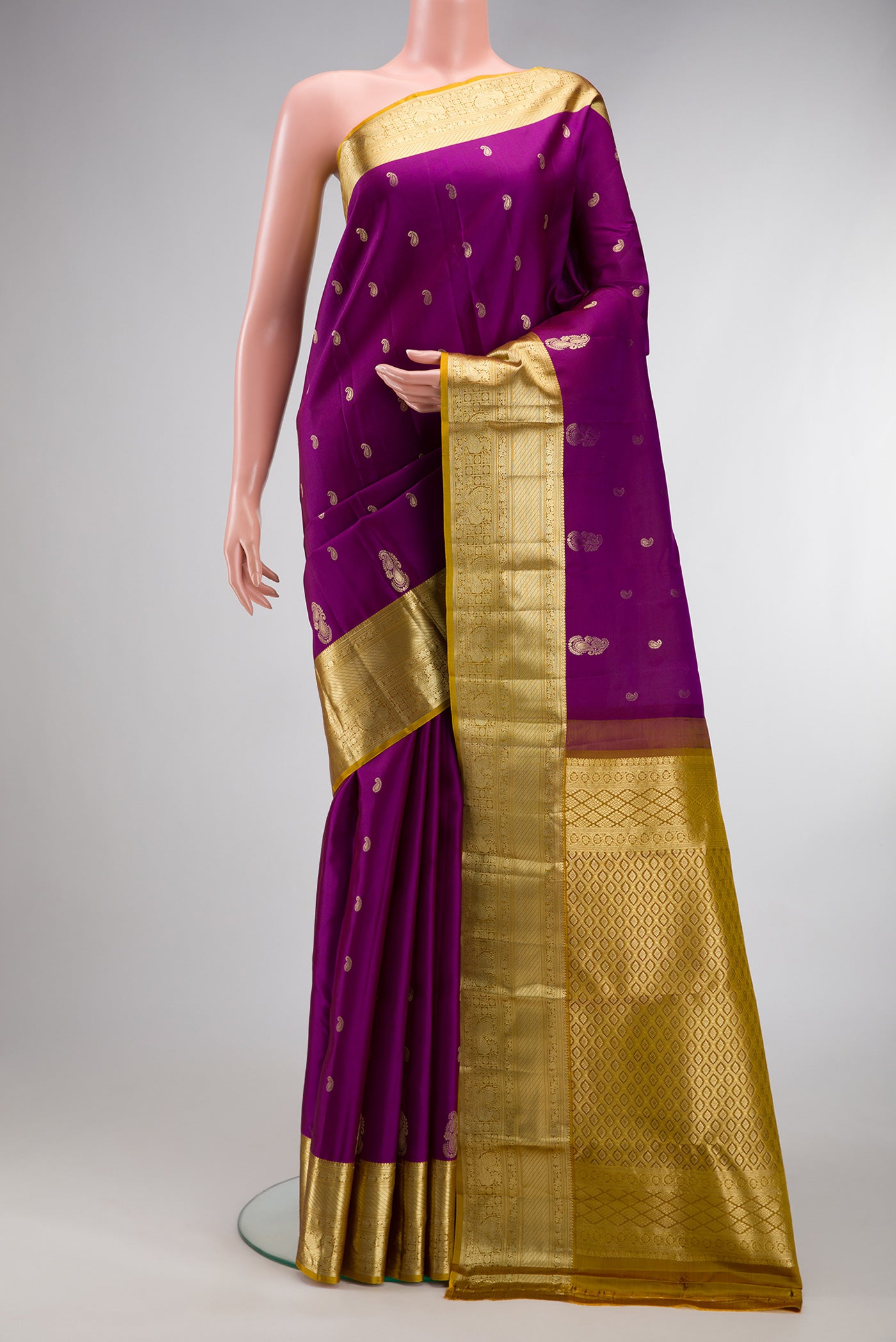 Purple Kanchipuram Silk Saree with Zari Butta on the body and Zari Border.  displayed on a mannequin