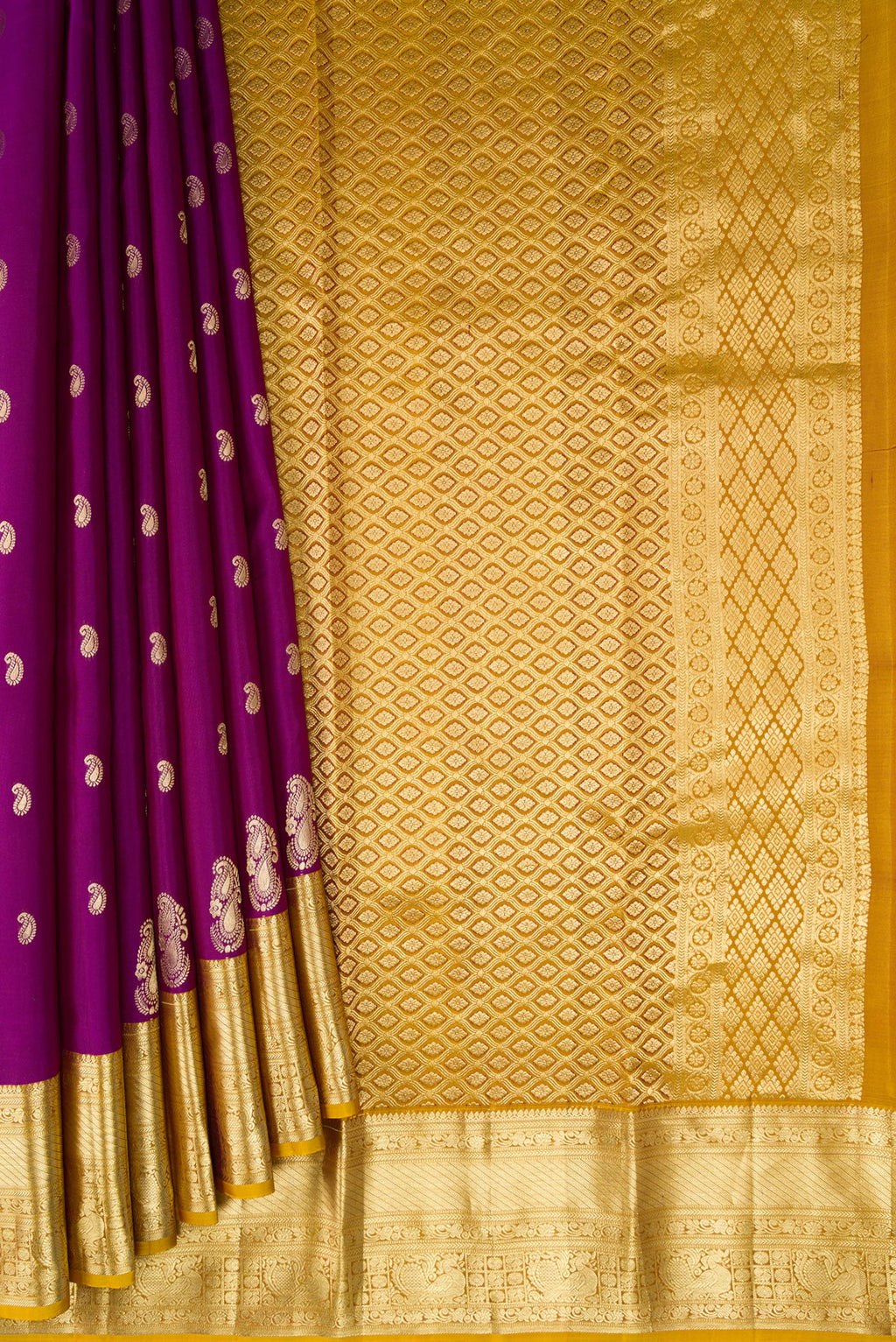 Pleats and pallu of Purple Kanchipuram Silk Saree with Zari Butta on the body and Zari Border. 