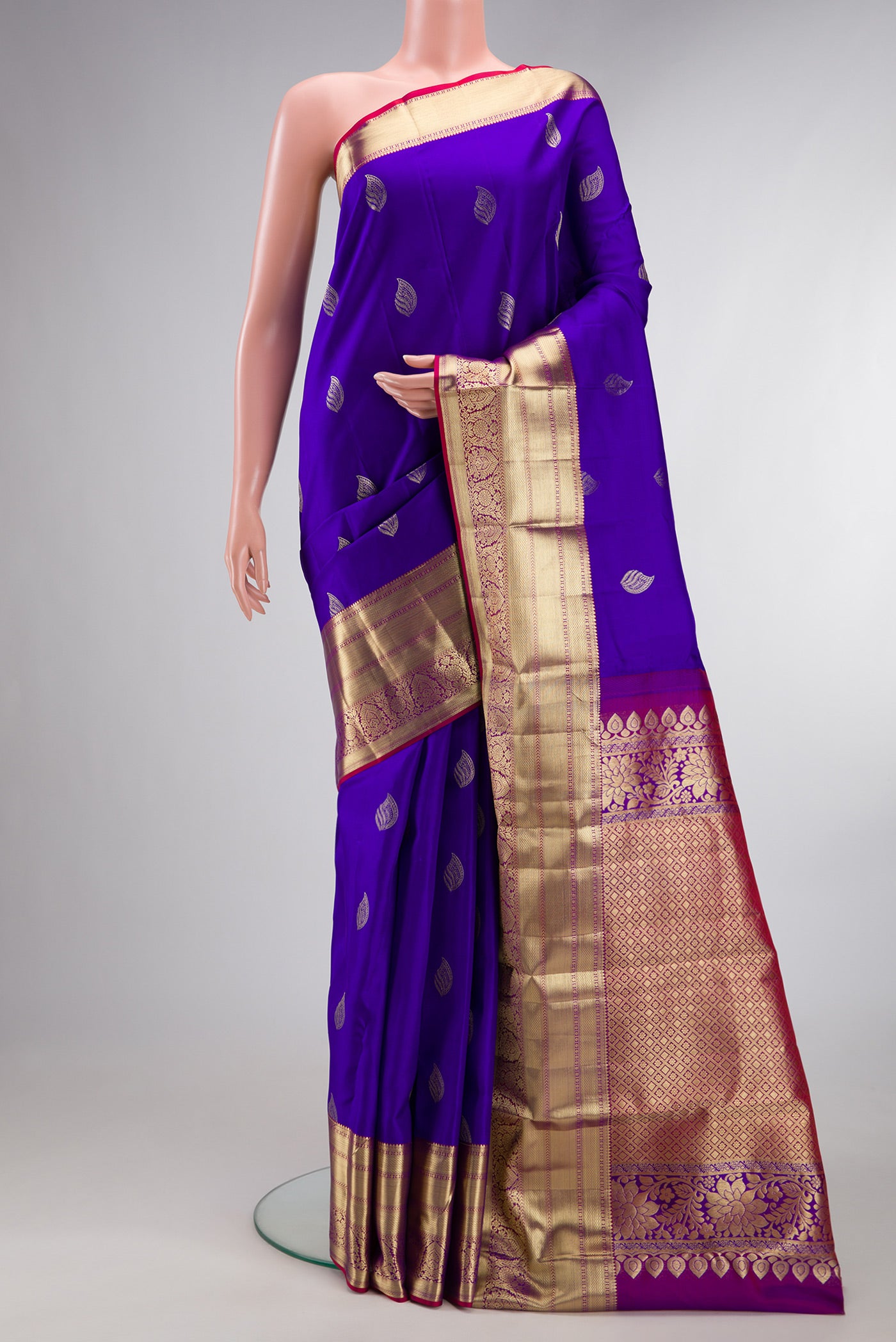 Pure Silk Royal Blue Kanchipuram Saree with Zari Butta on the body and Zari Border.  displayed on a mannequin