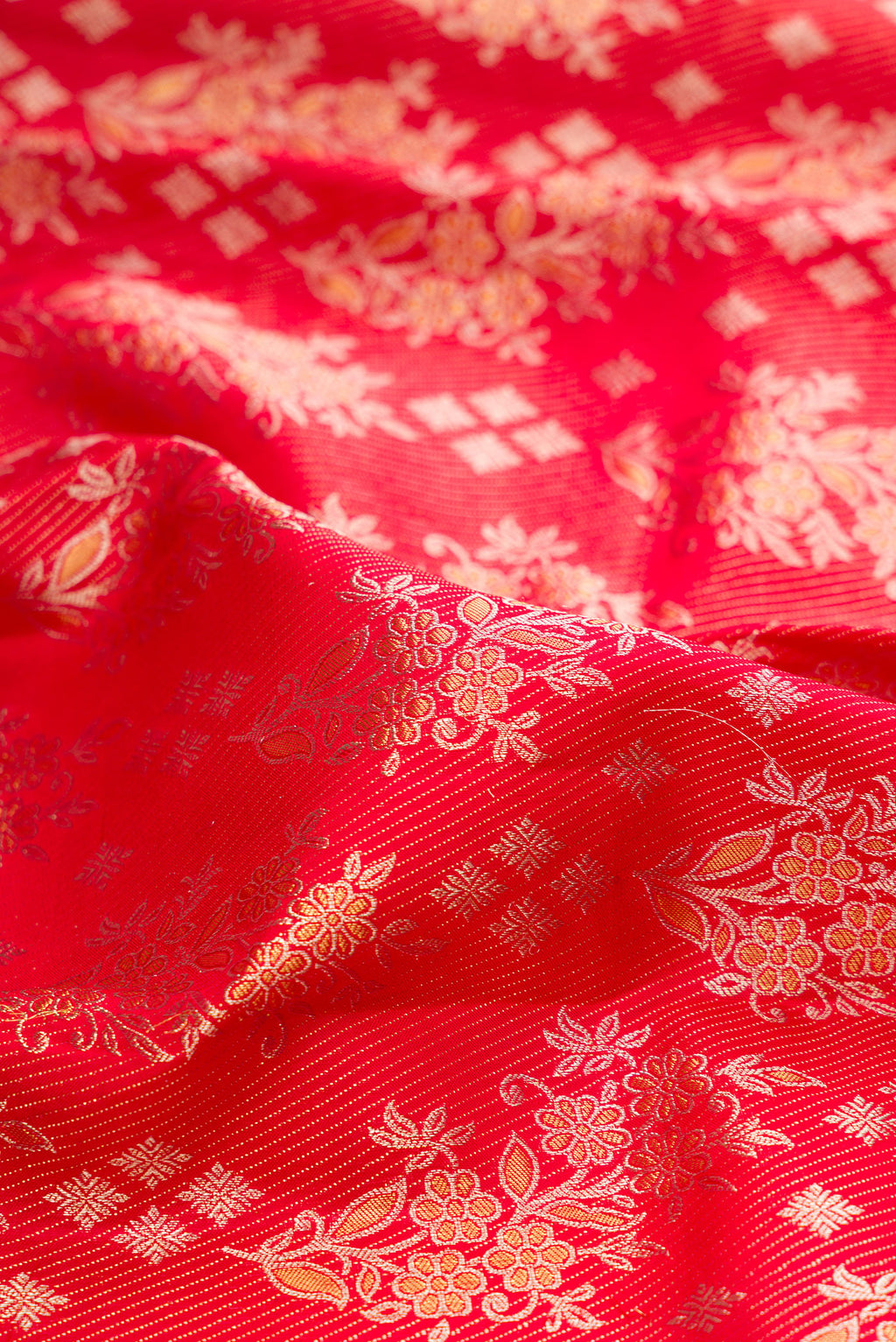 Close up of Red Kanjivaram Silk Saree with Zari Brocade on the body and Zari Border.  displaying folds