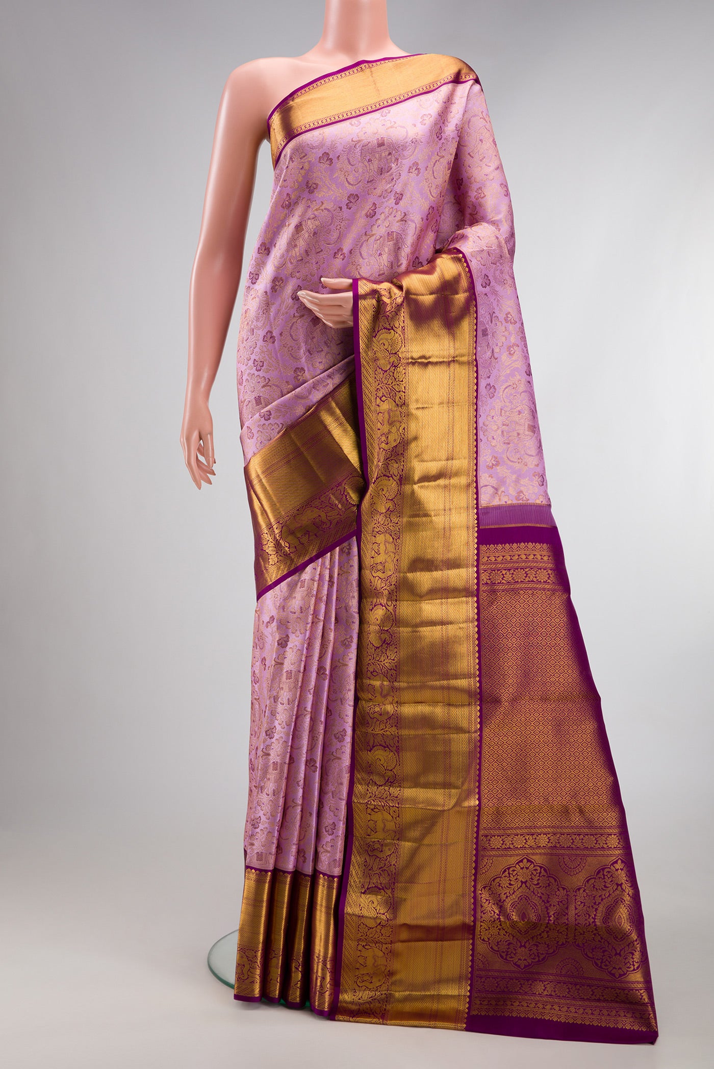Lavender Kanjivaram Silk Saree with Zari Brocade on the body and Zari Border.  displayed on a mannequin