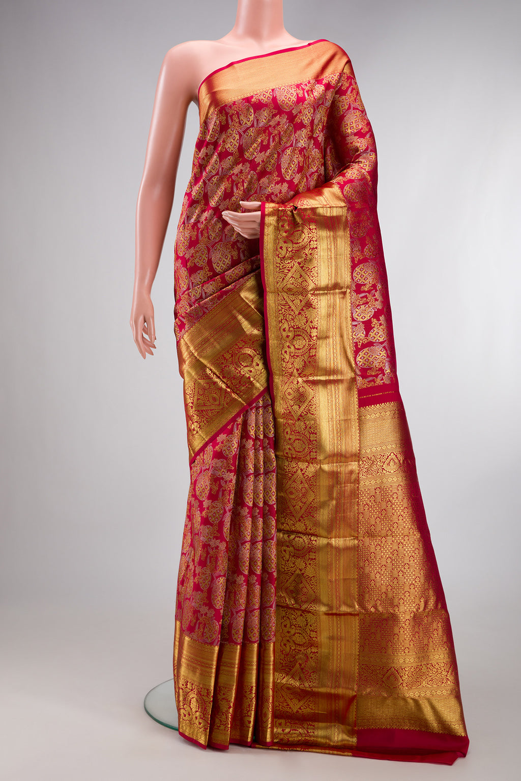 Maroon Kanjivaram Silk Saree with Zari Brocade on the body and Zari Border.  displayed on a mannequin