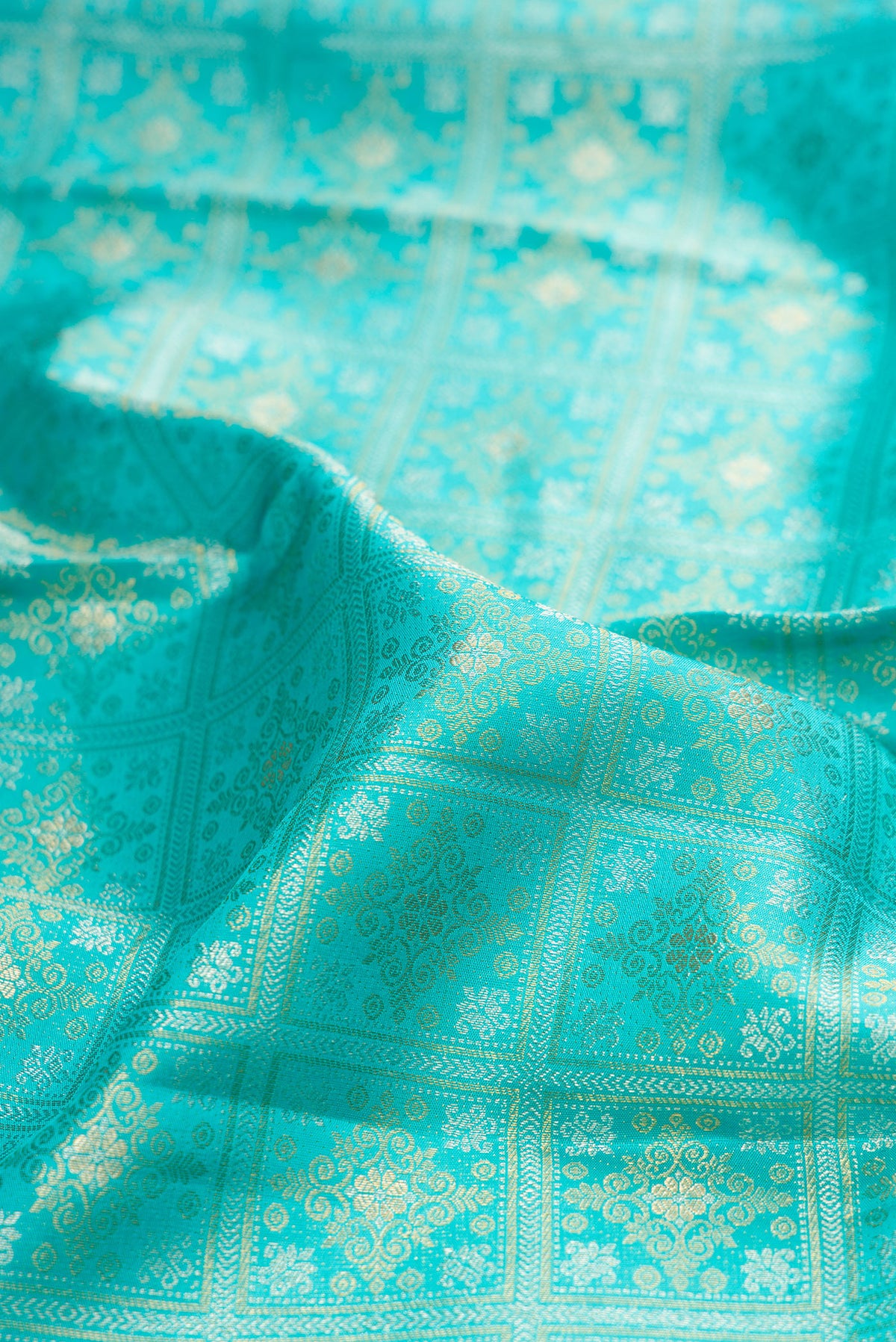 Close up of Sky Blue Kanjivaram Silk Saree with Zari Brocade on the body and Zari Border.  displaying folds