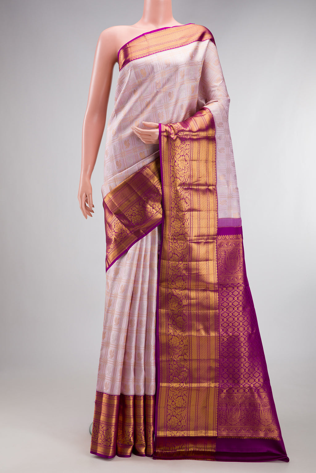 Lilac Kanjivaram Silk Saree with Checked design on the body and Zari Border.  displayed on a mannequin