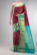 Pure Silk Magenta Kanjivaram Saree with Zari Brocade on the body and Zari Border.  displayed on a mannequin