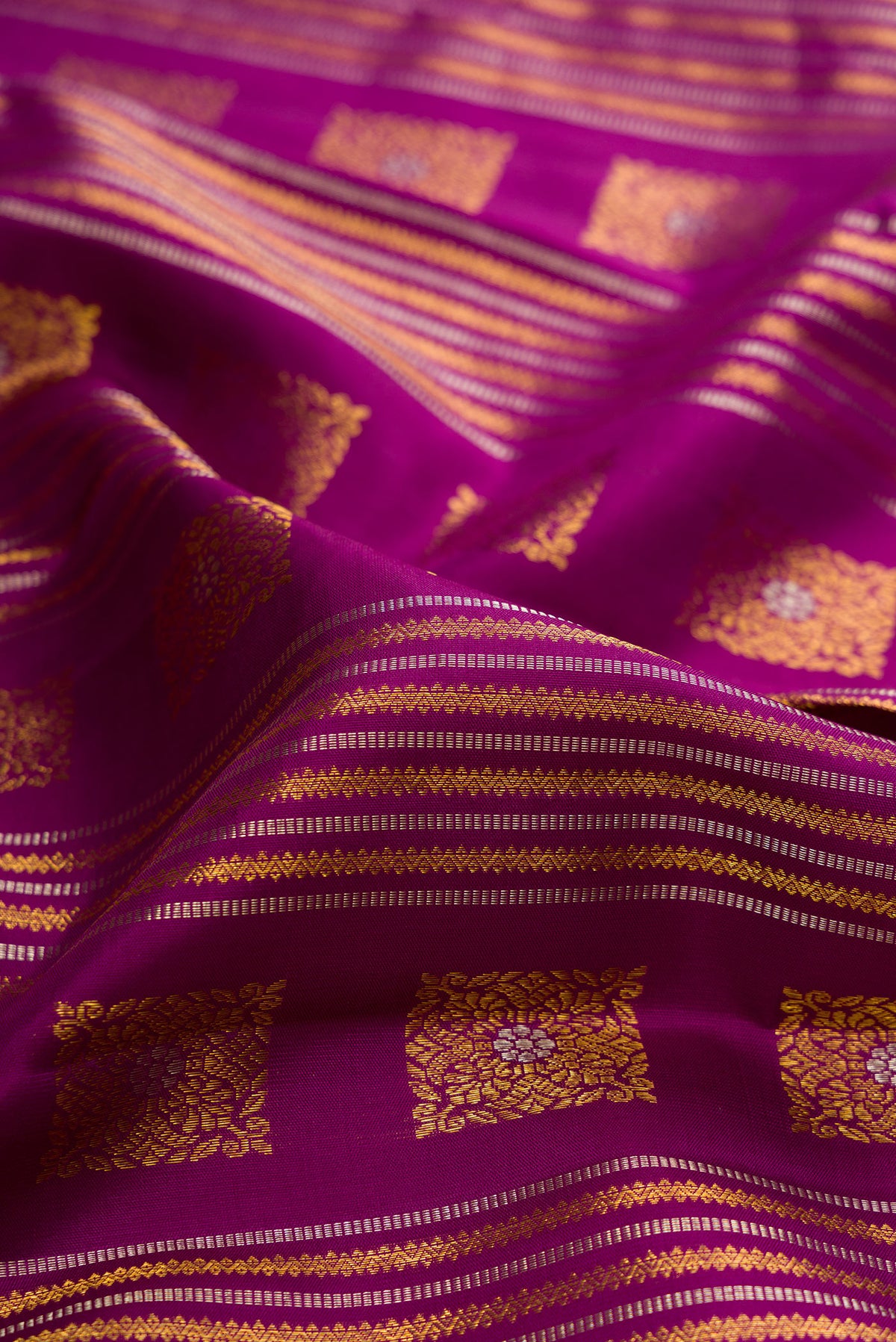 Close up of Pure Silk Purple Kanjivaram Saree with Zari Brocade on the body and Zari Border.  displaying folds