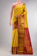 Pure Silk Mustard Kanjivaram Saree with Zari Brocade on the body and Zari Border.  displayed on a mannequin