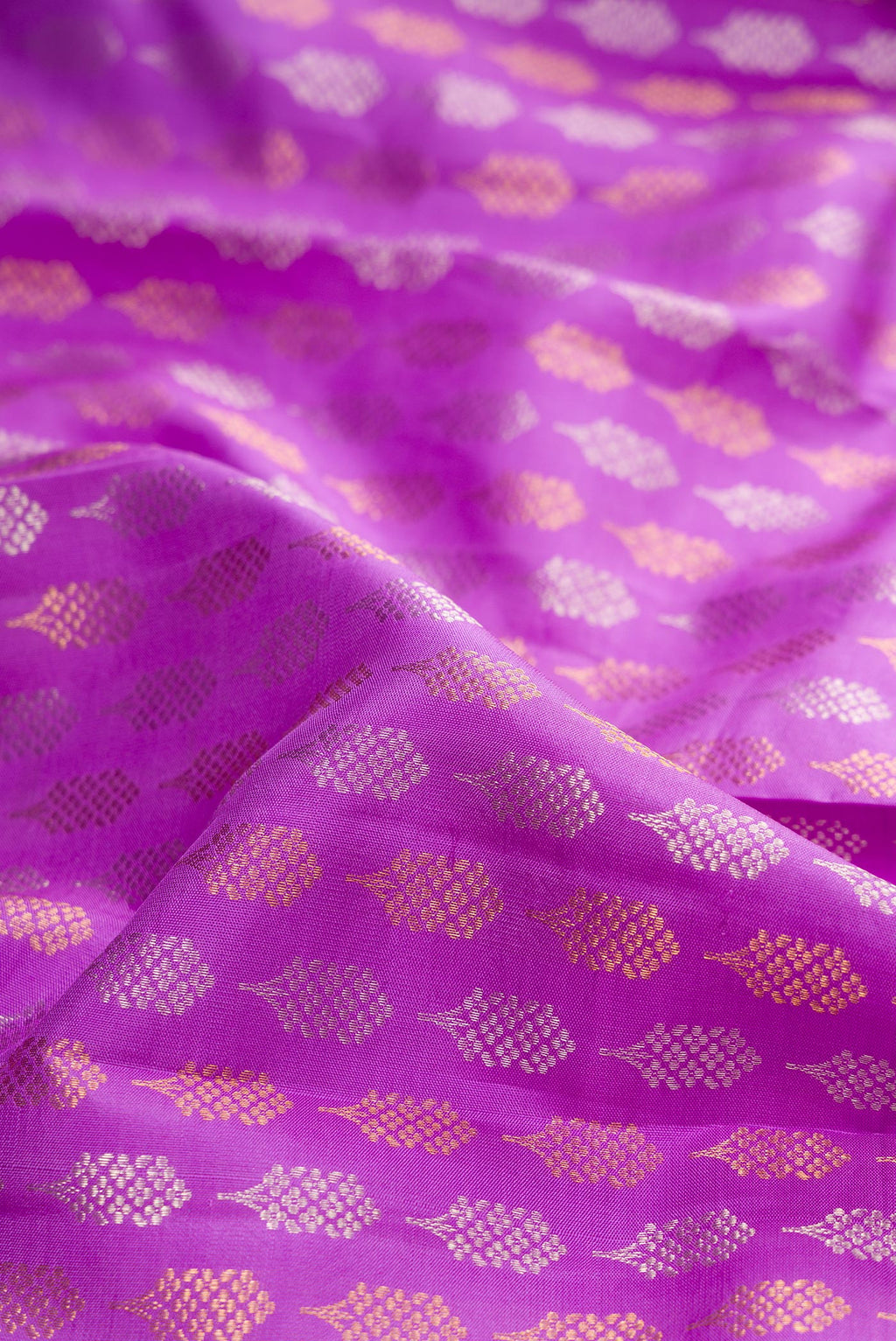 Close up of Pure Silk Lavender Kanjivaram Saree with Zari Brocade on the body and Zari Border.  displaying folds